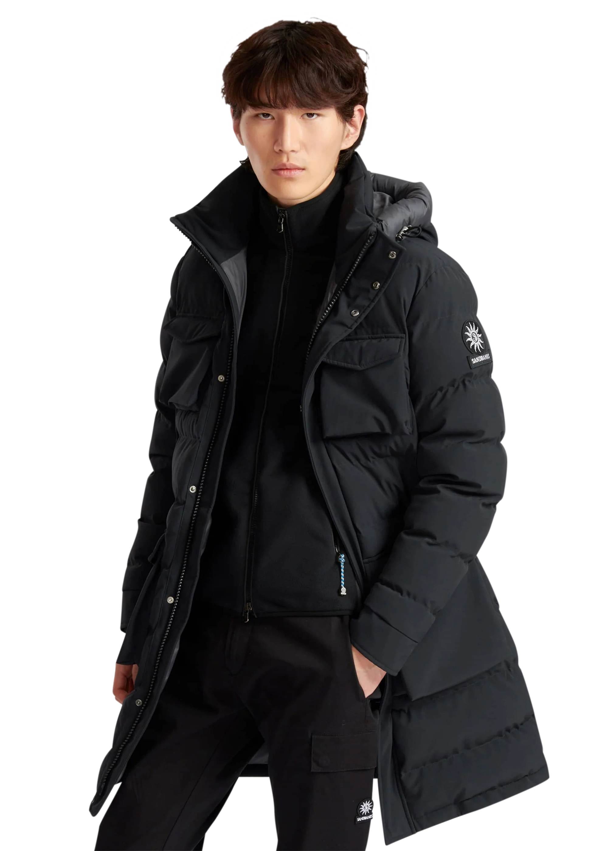 Person wearing a black winter coat with a brand logo on a white background