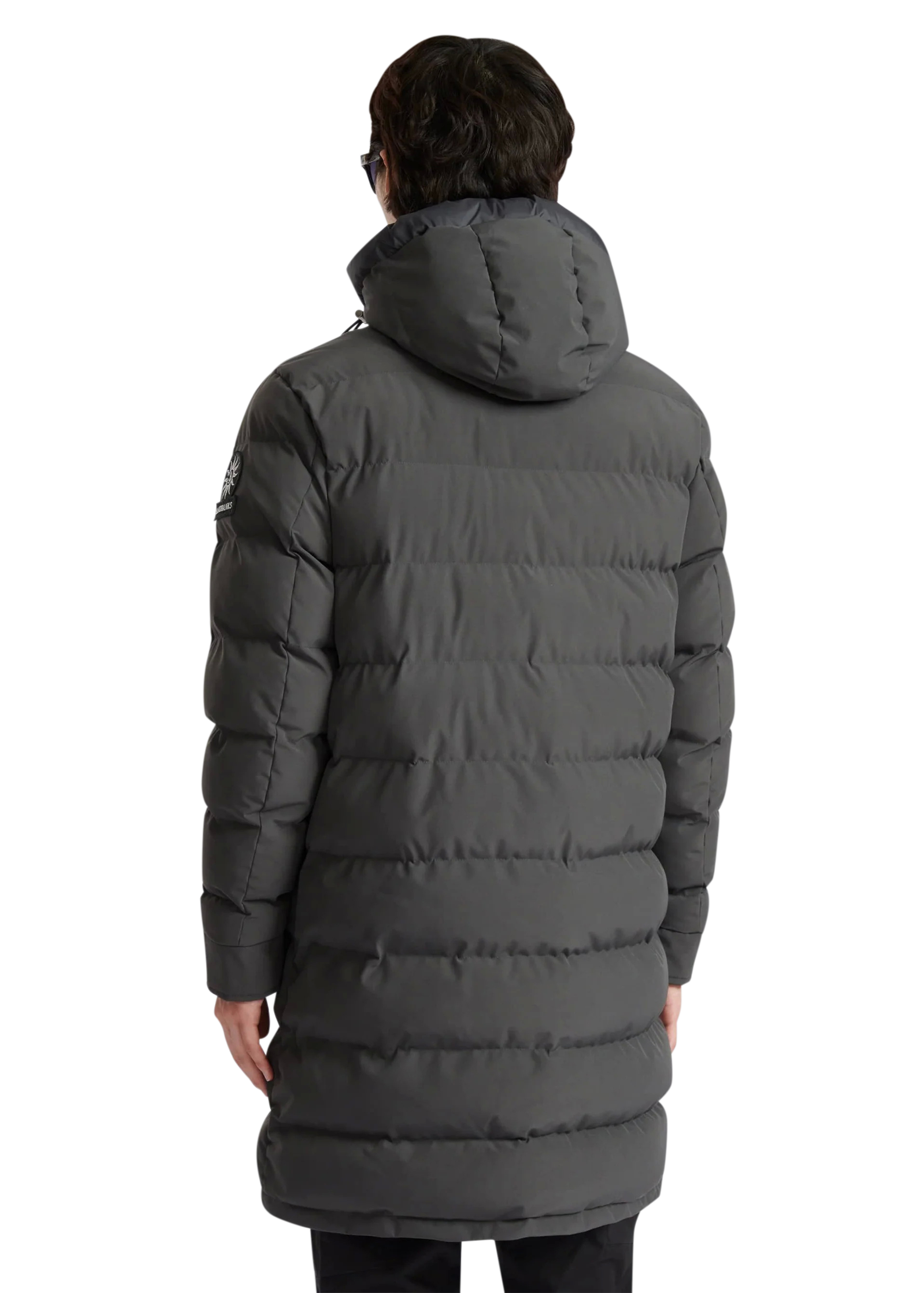 Person wearing a long gray puffer coat on a white background