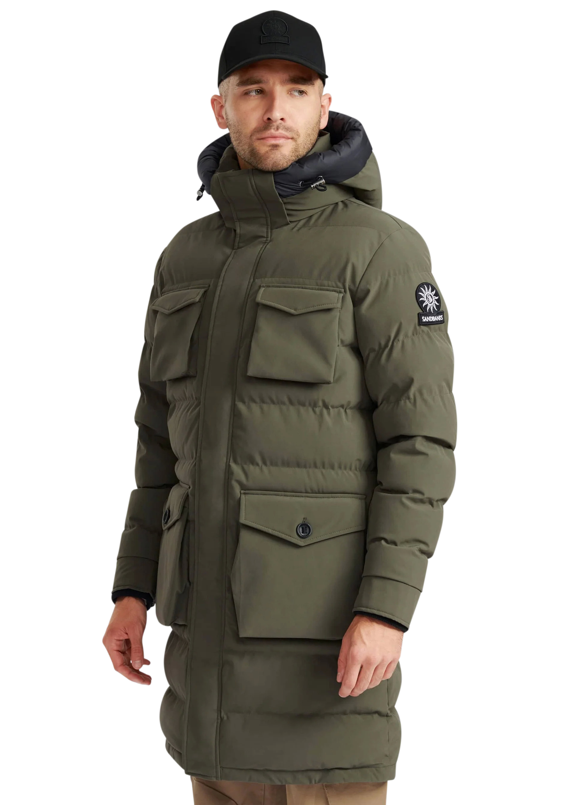 Man wearing a green winter coat with a brand logo on a white background