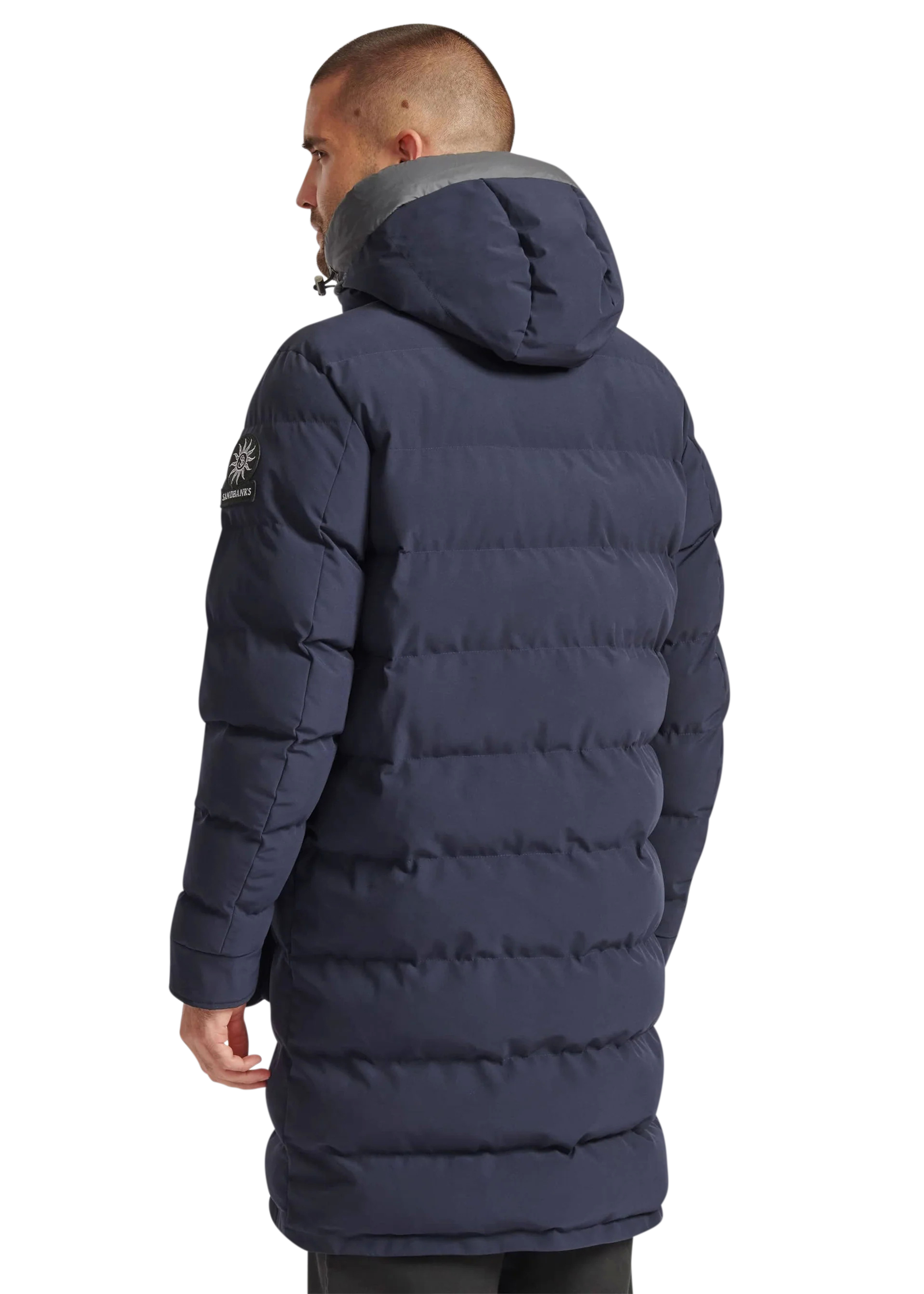 Man wearing a navy blue puffer jacket on a white background