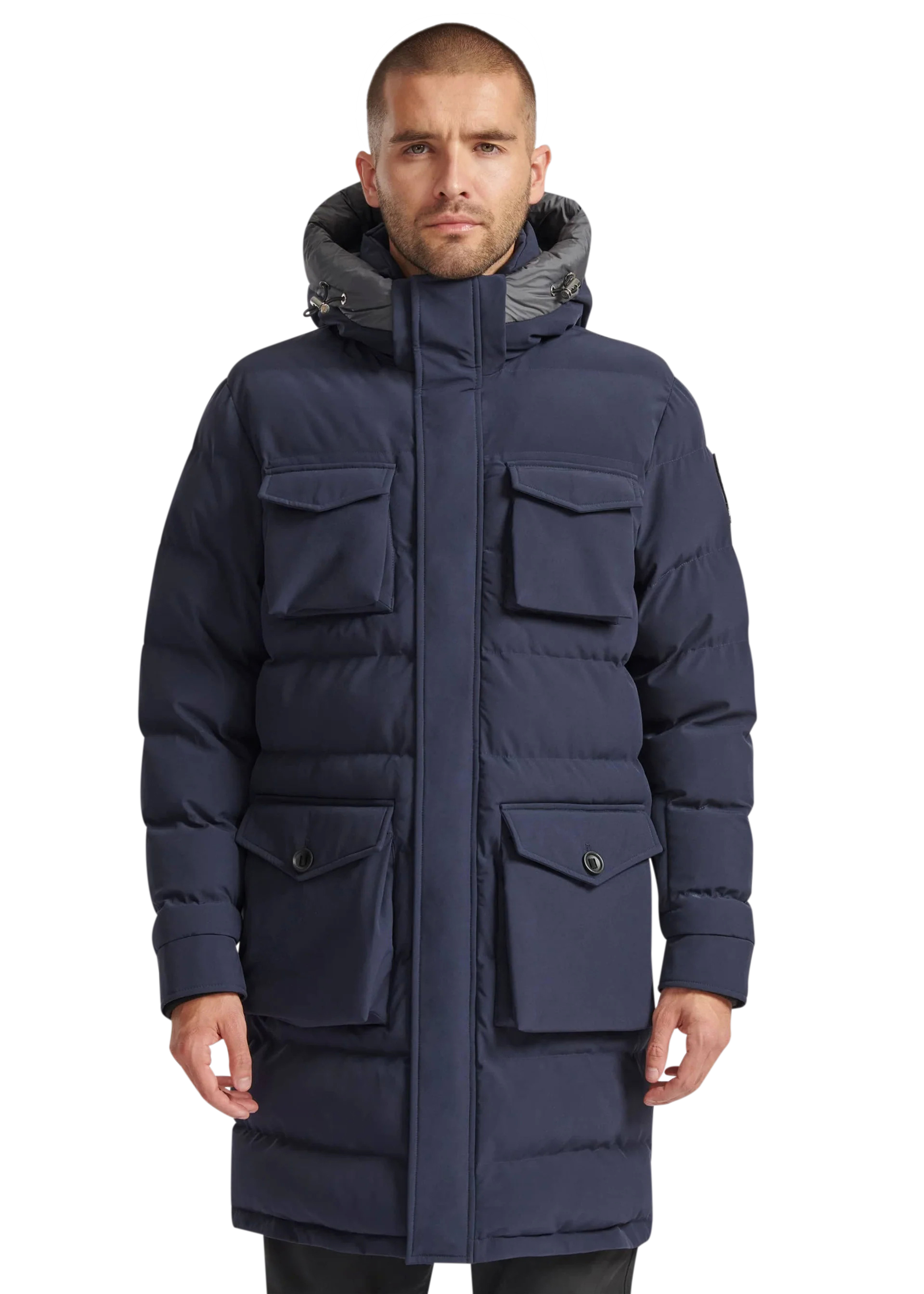 Man wearing a navy blue winter coat with a hood on a white background