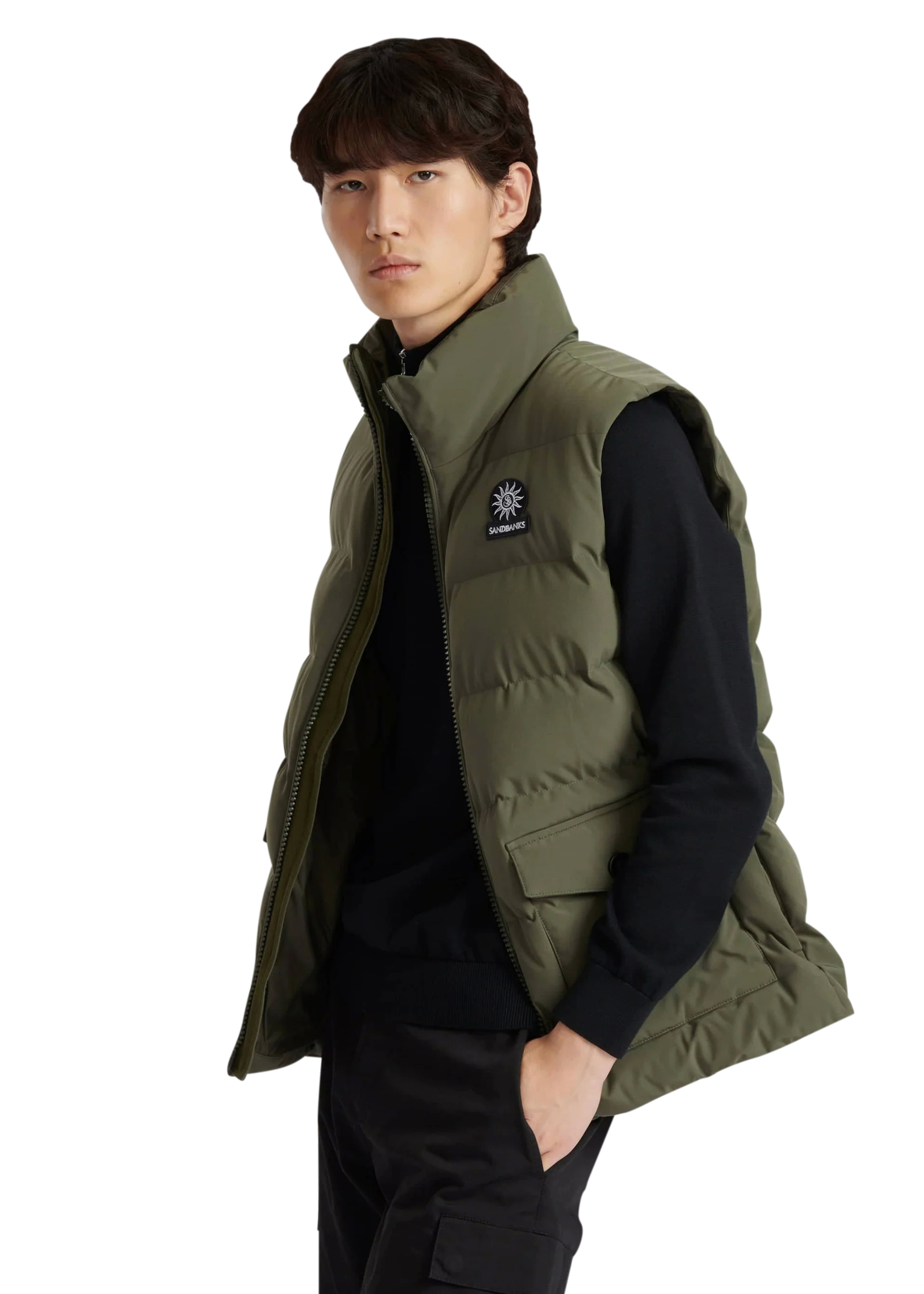 Man wearing a green puffer vest with a logo on a white background