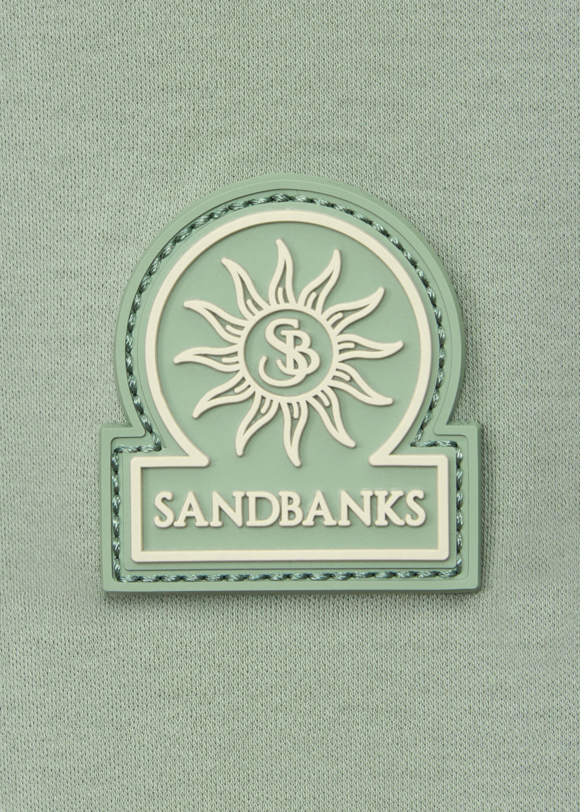 Model wearing Sandbanks Silicone Zip Polo Shirt - Sage