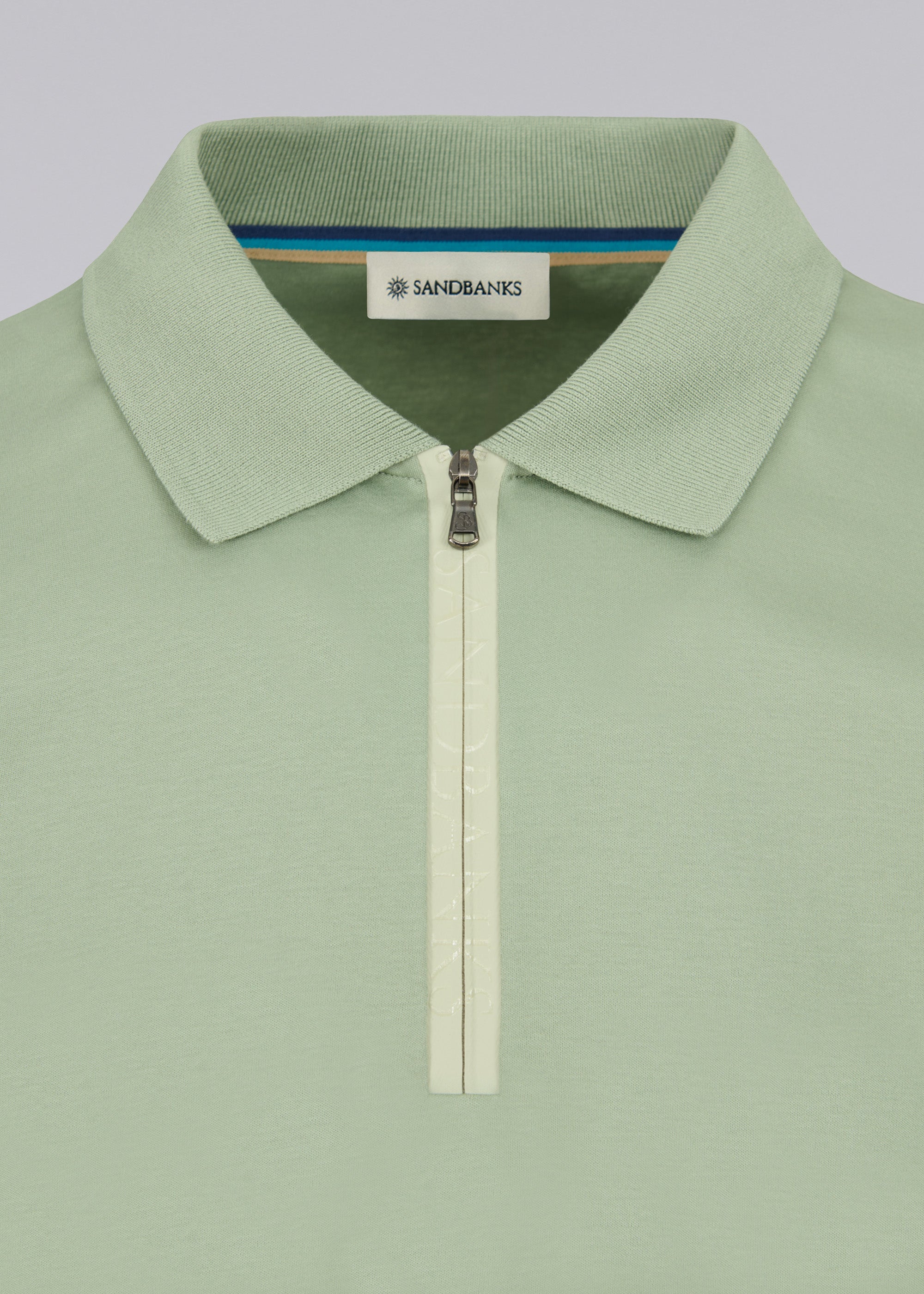 Model wearing Sandbanks Silicone Zip Polo Shirt - Sage