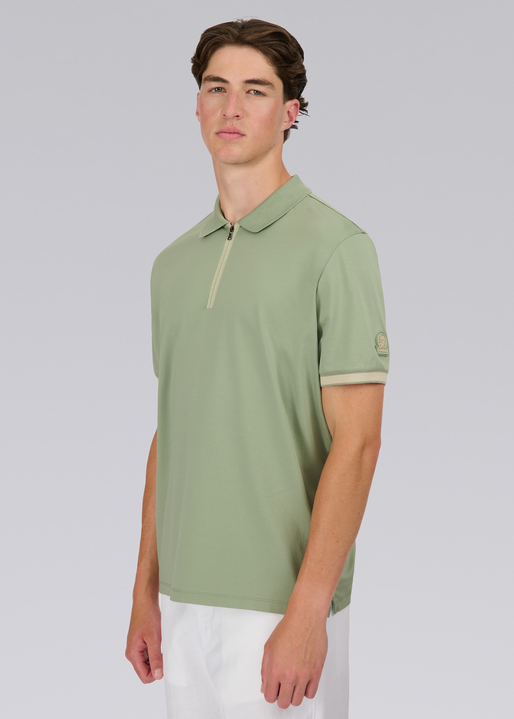 Model wearing Sandbanks Silicone Zip Polo Shirt - Sage