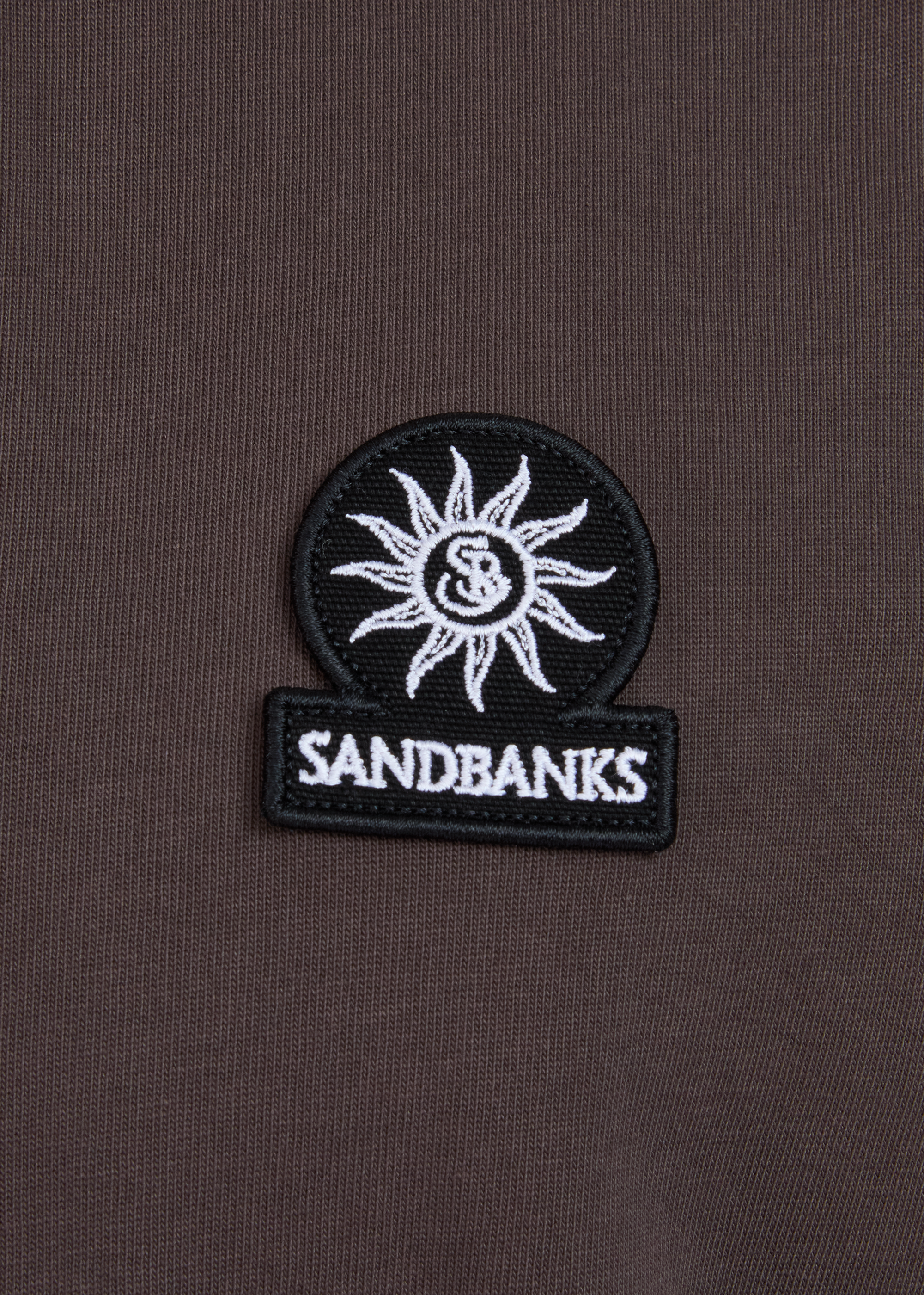 Sandbanks logo patch on a brown background