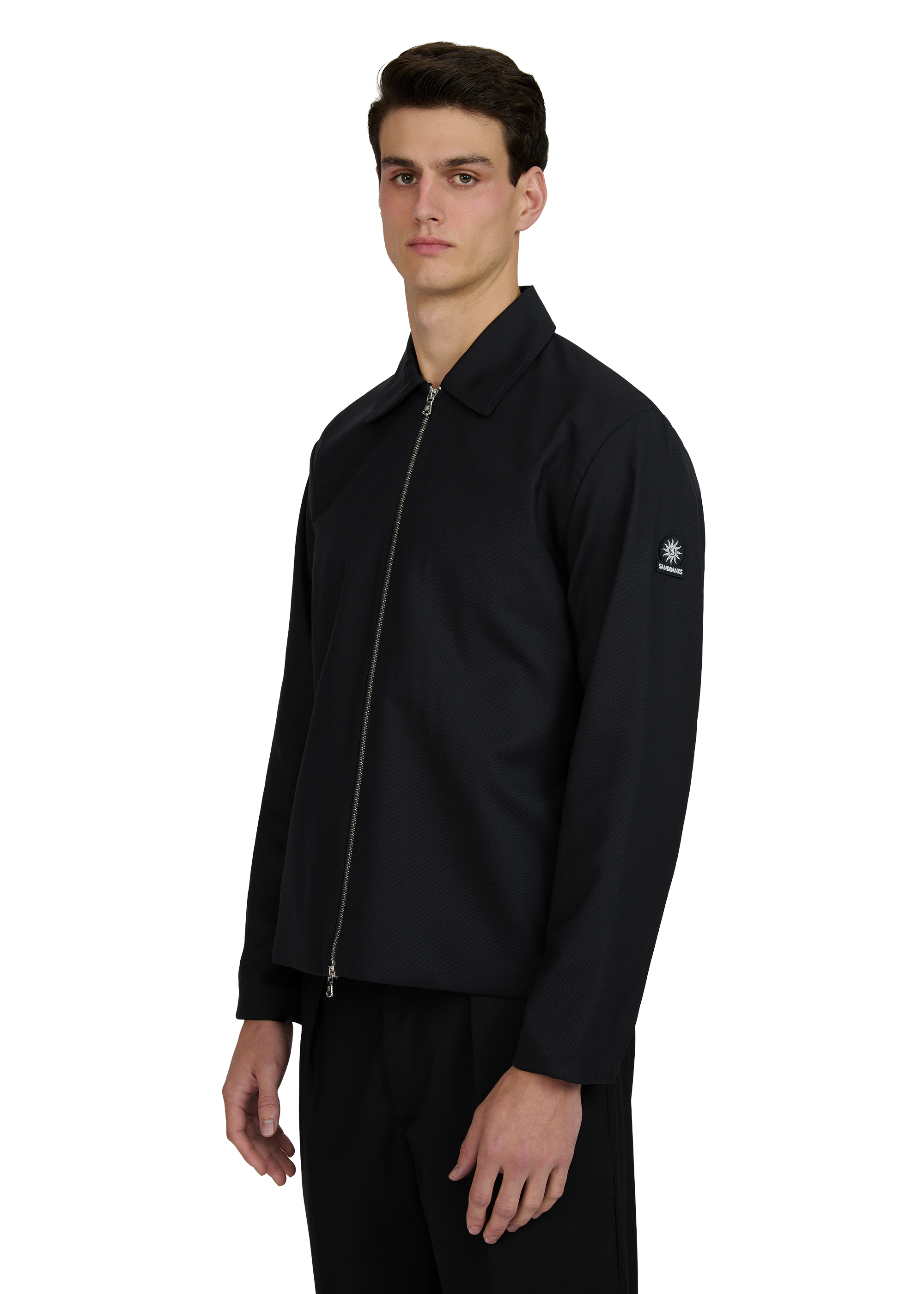 Man wearing a black jacket with a brand logo on a white background