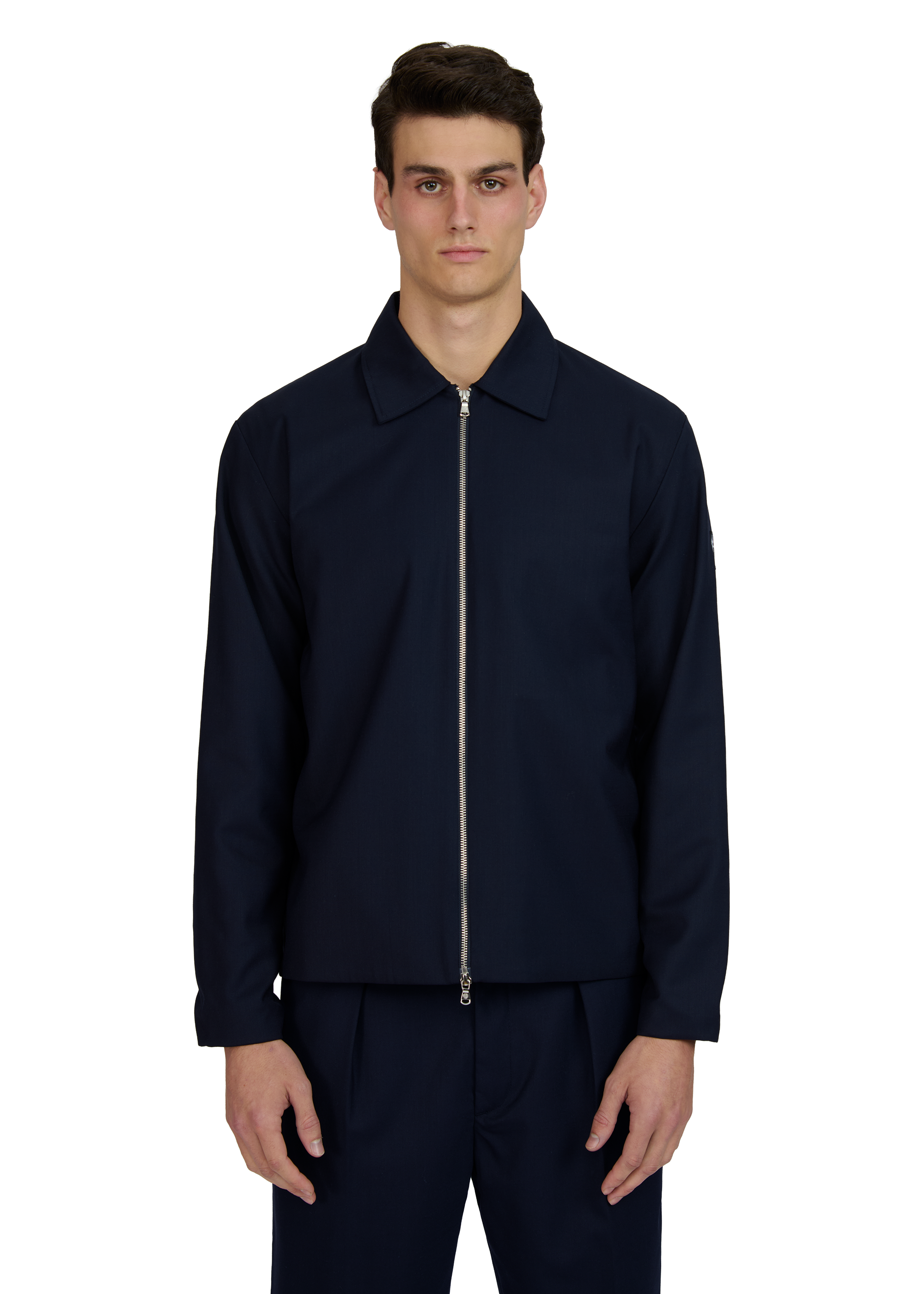 Man wearing a navy blue jacket and pants on a white background