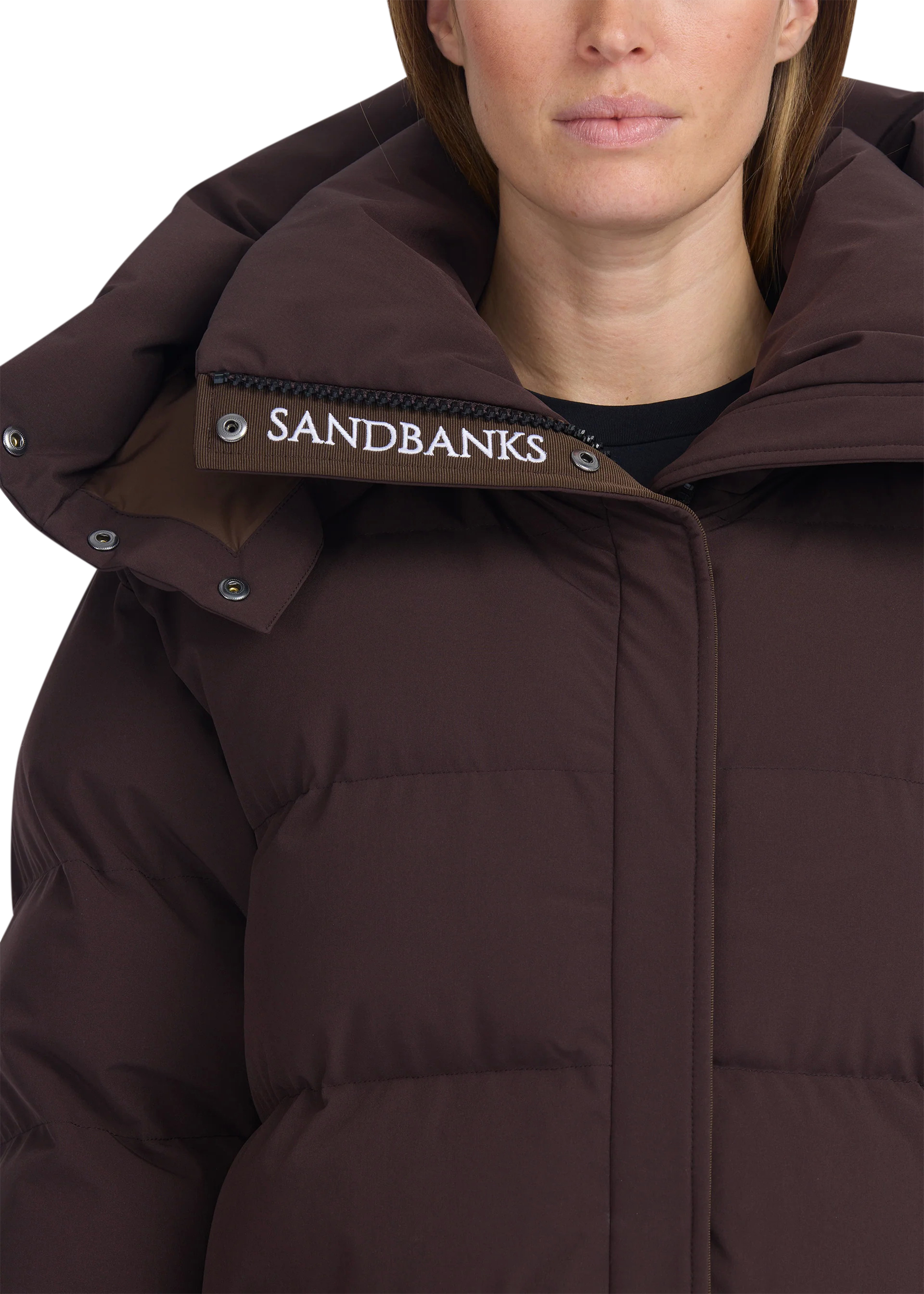 Brown puffer jacket with 'Sandbanks' logo on hood