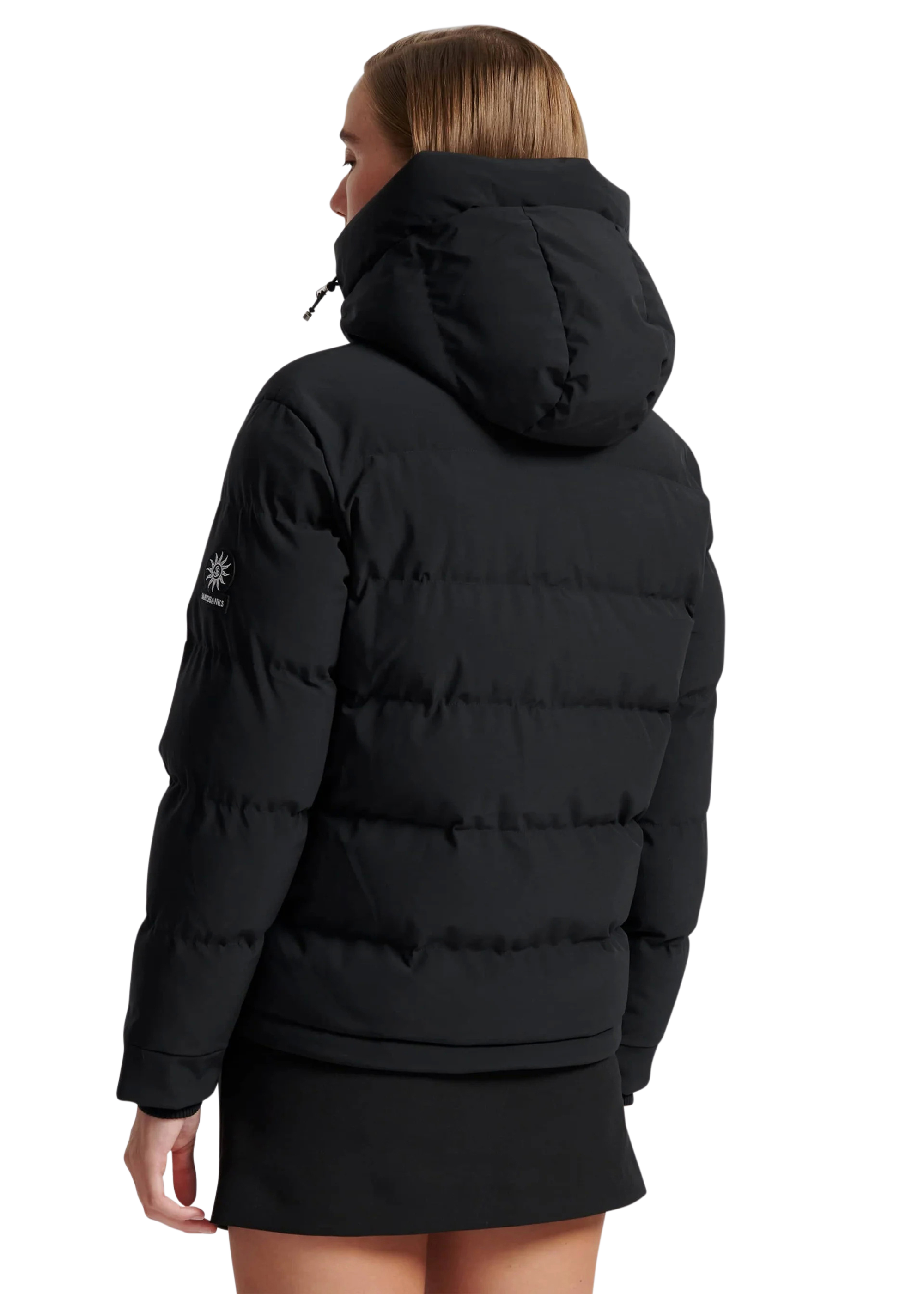 Person wearing a black puffer jacket with a hood on a white background