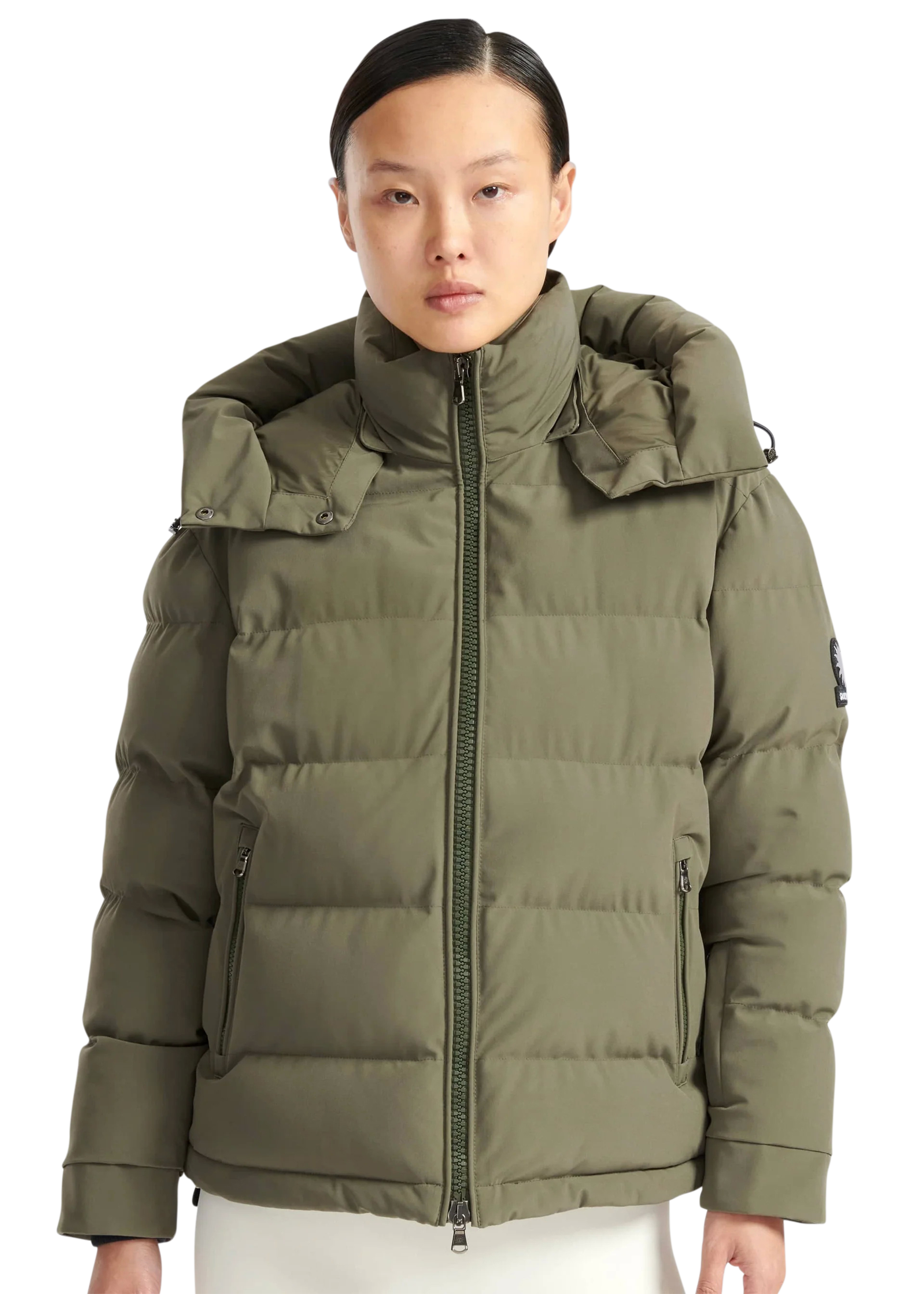 Person wearing a green puffer jacket on a white background