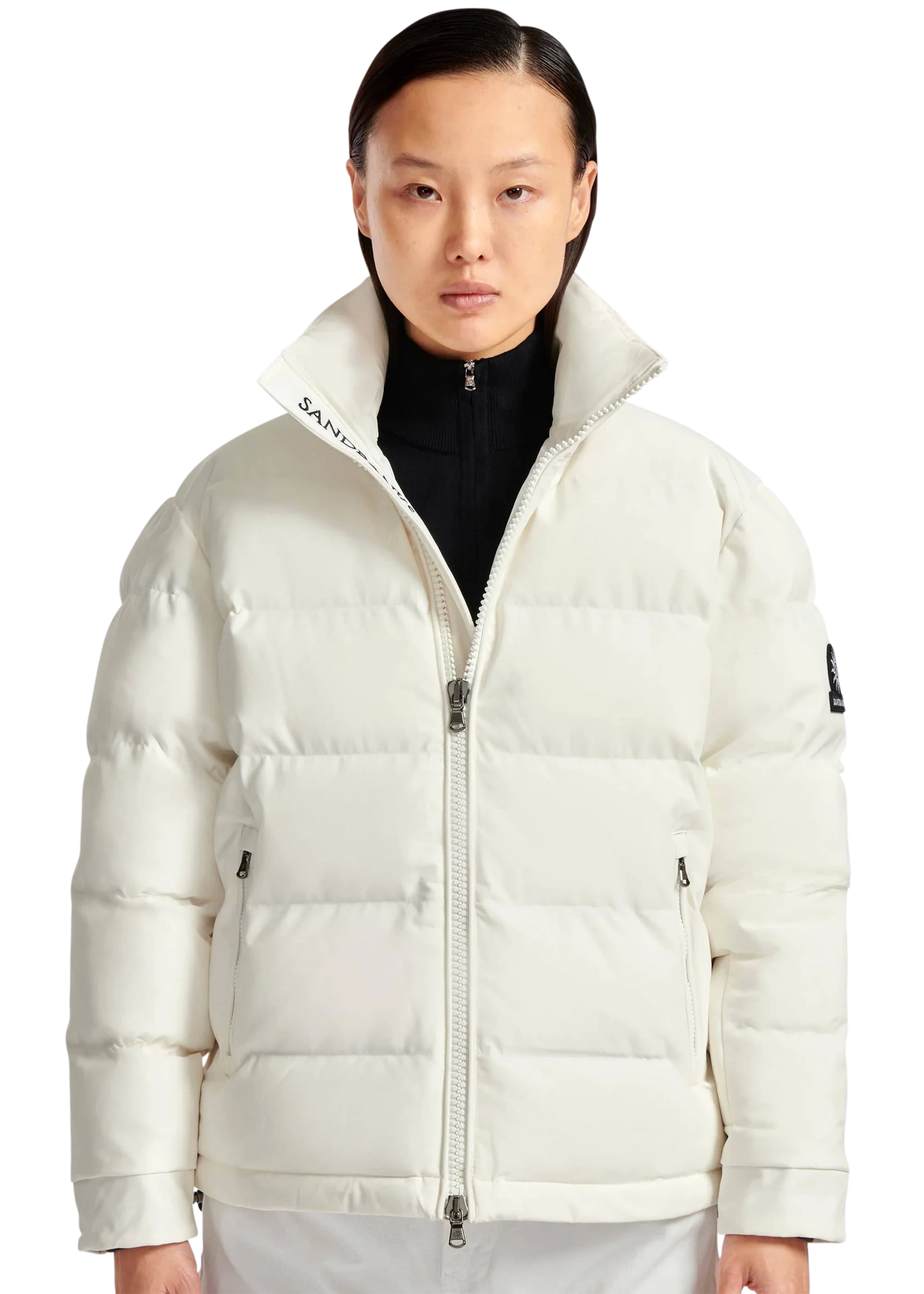 Person wearing a white puffer jacket with a brand logo on a white background