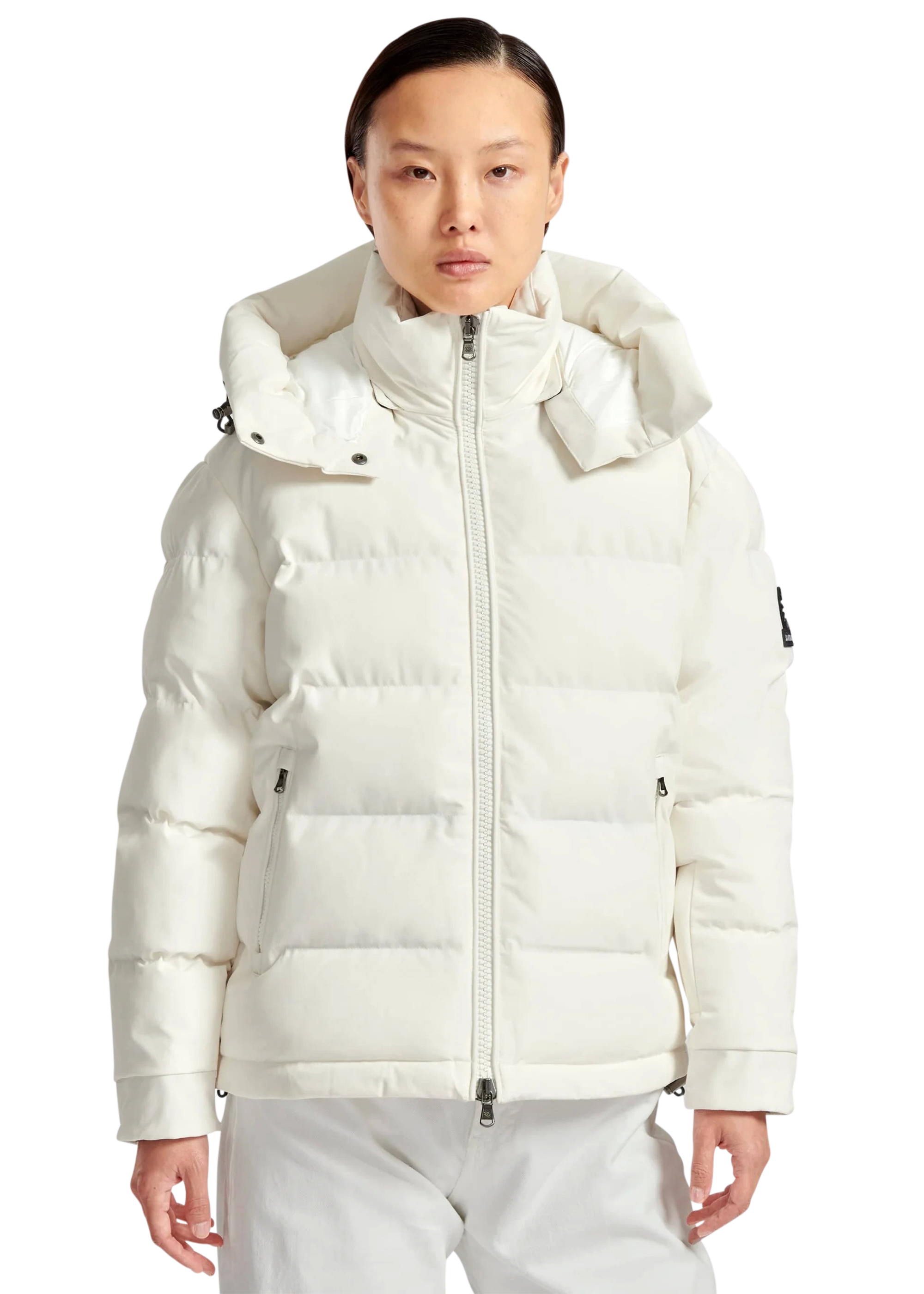 Person wearing a white puffer jacket on a white background