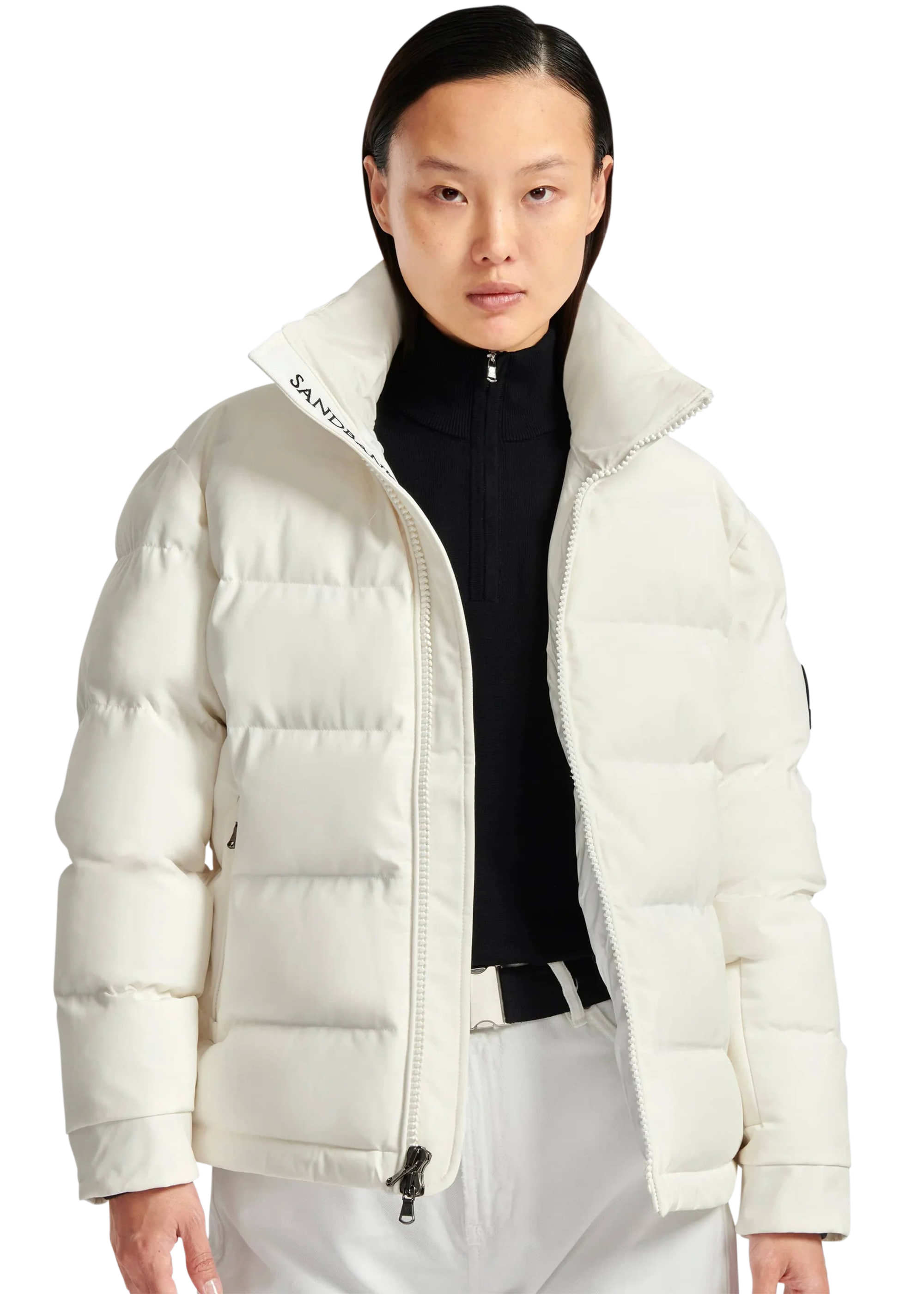 Person wearing a white puffer jacket with a visible brand logo on a white background