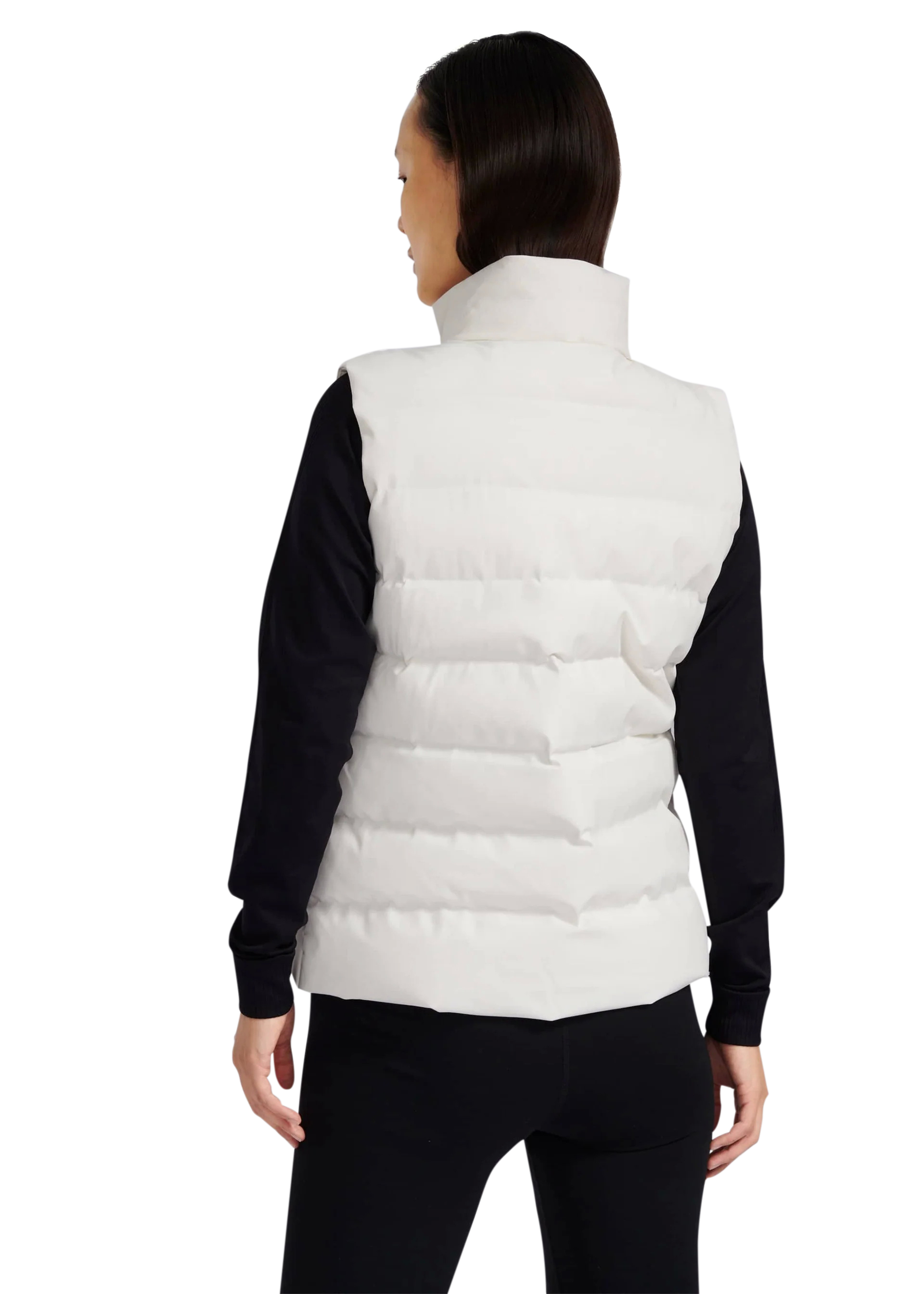 Person wearing a white puffer vest over a black long-sleeve shirt on a white background