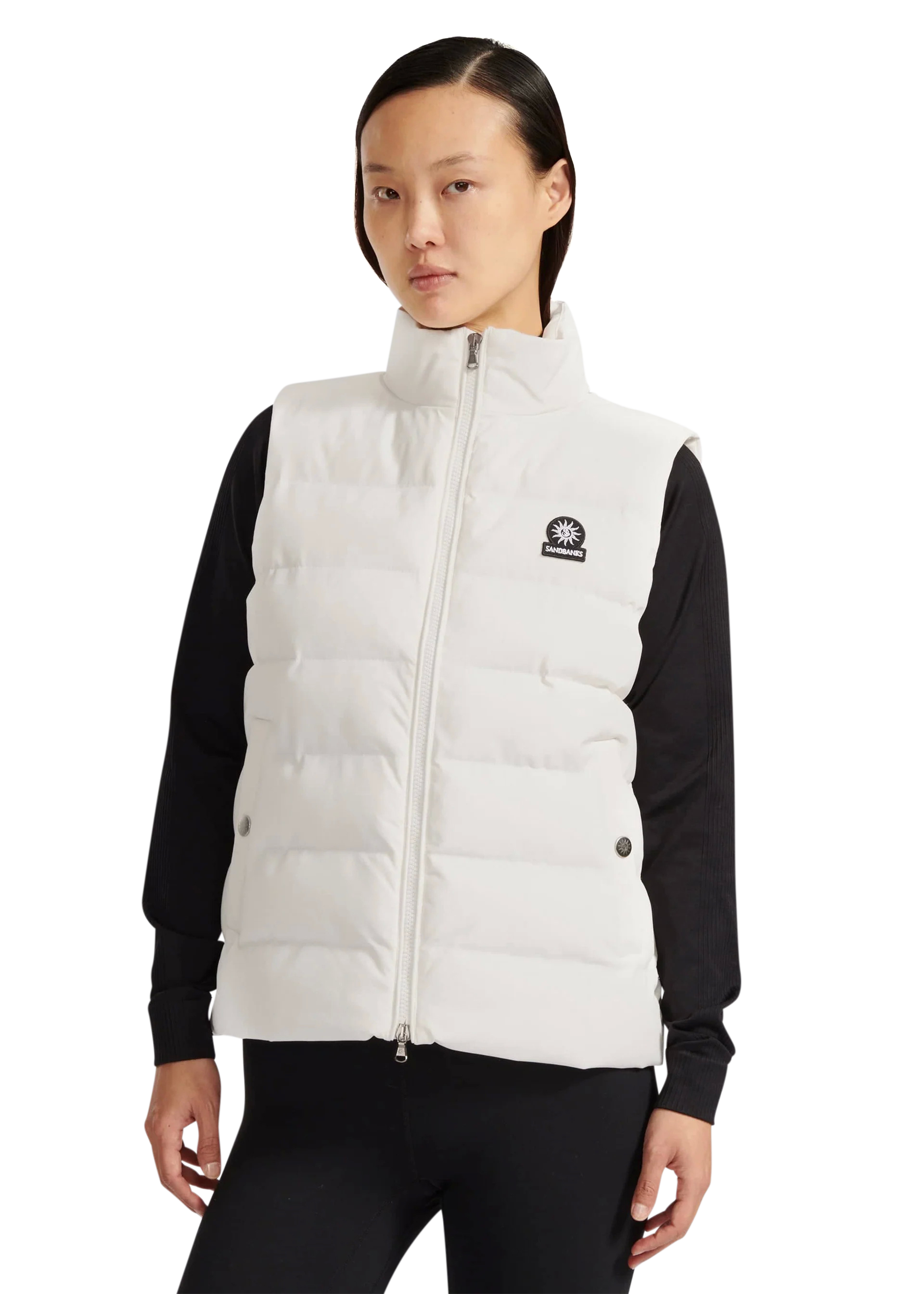 Person wearing a white puffer vest with a brand logo on a white background