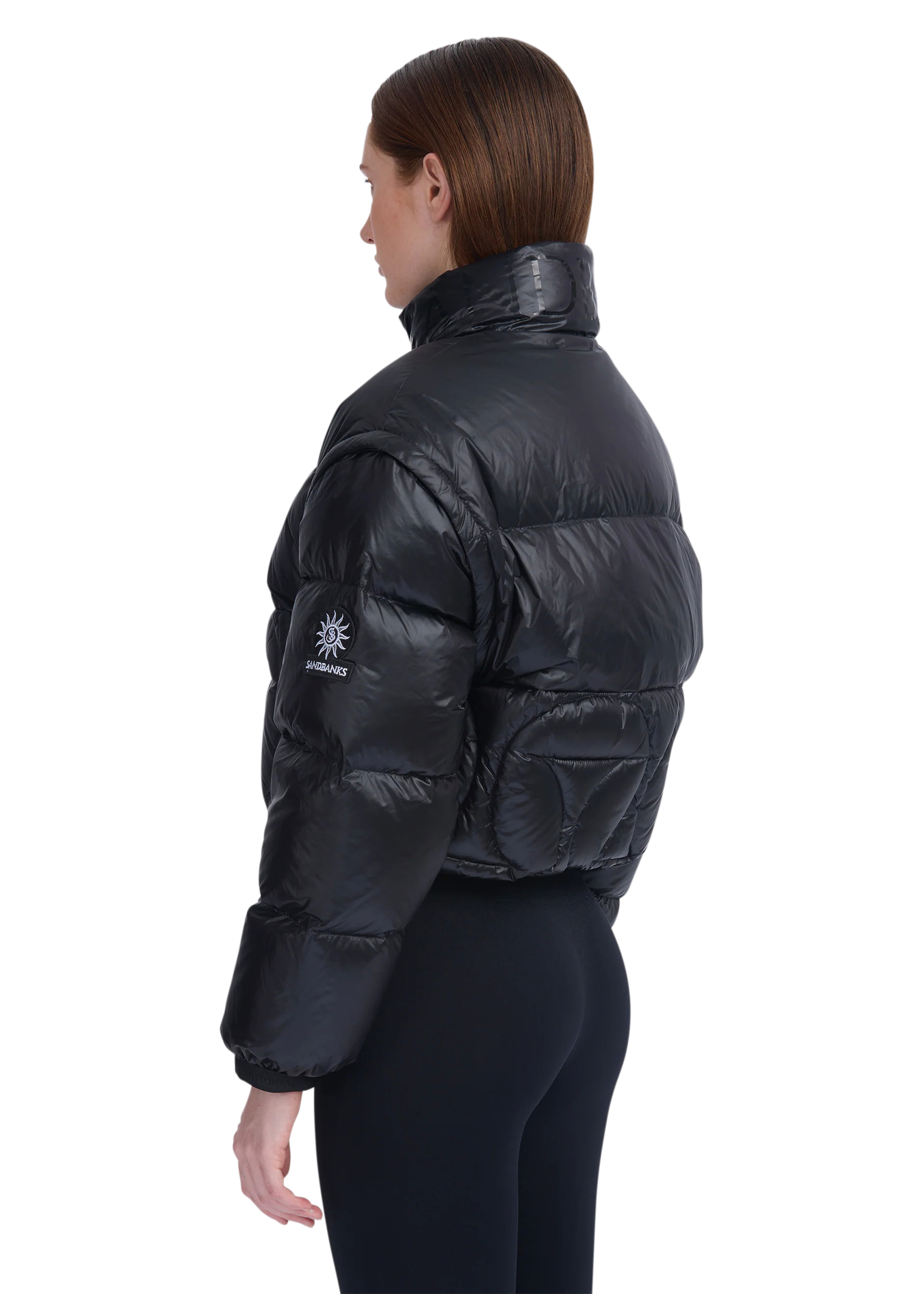 Person wearing a black puffer jacket with a visible brand logo on a white background