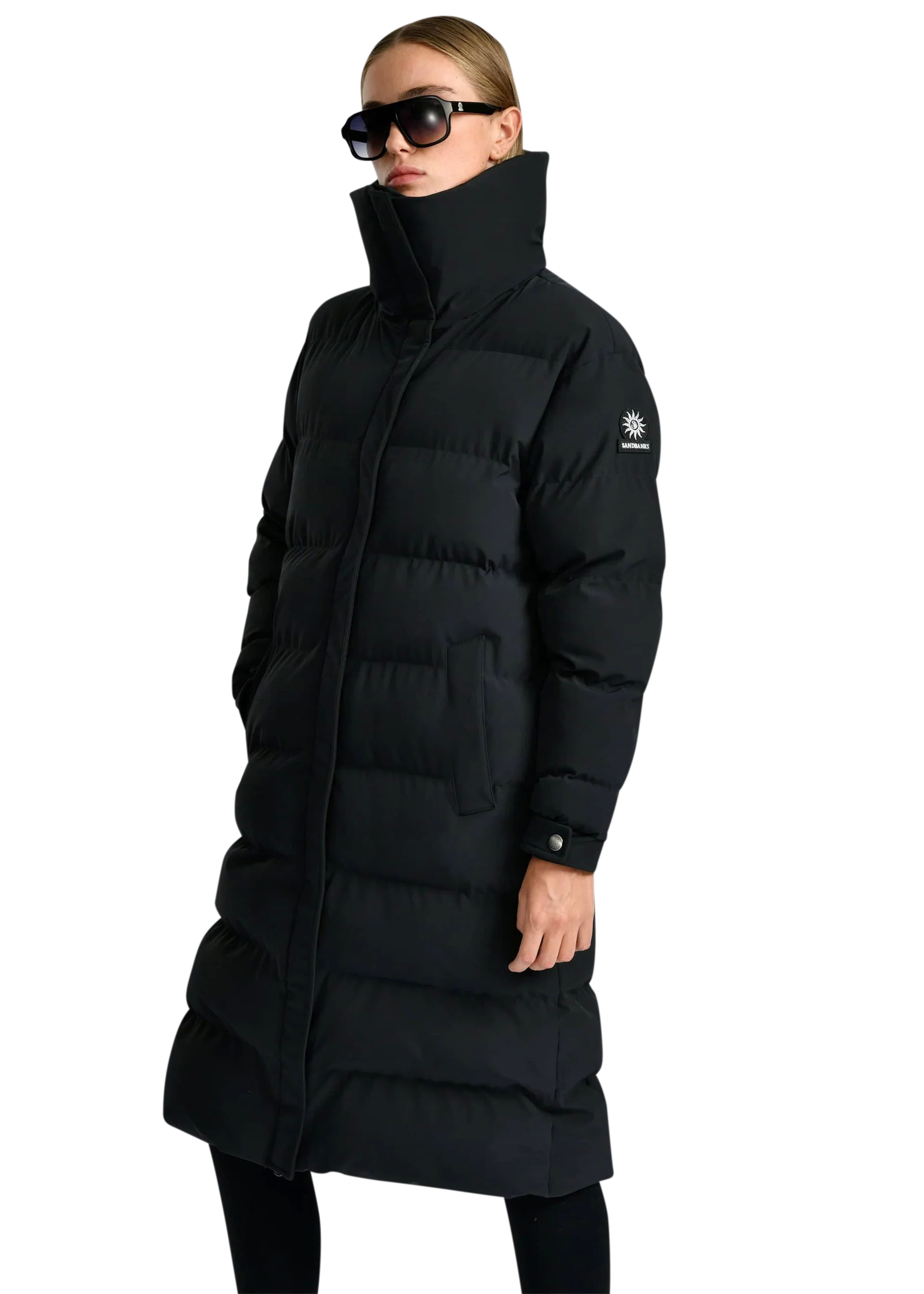 Person wearing a black puffer coat on a white background