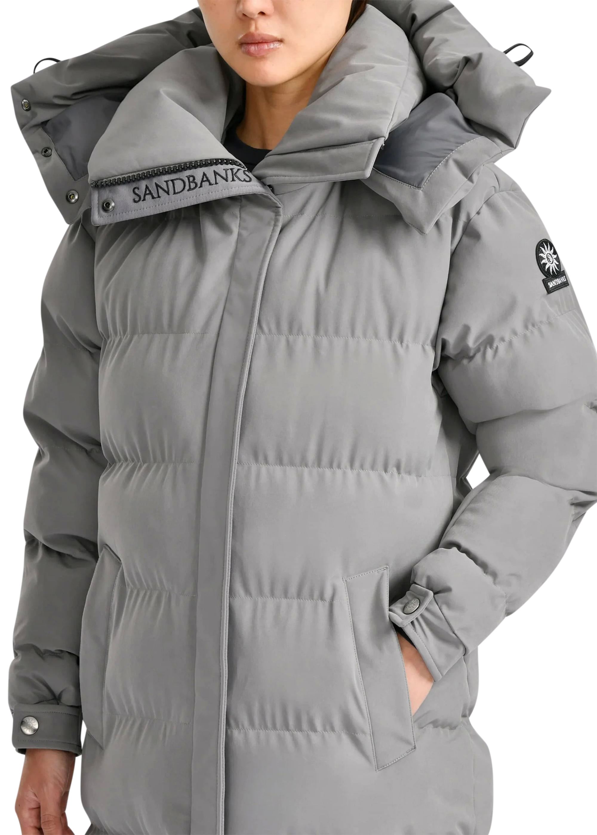 Gray puffer jacket with Sandbanks branding on a white background