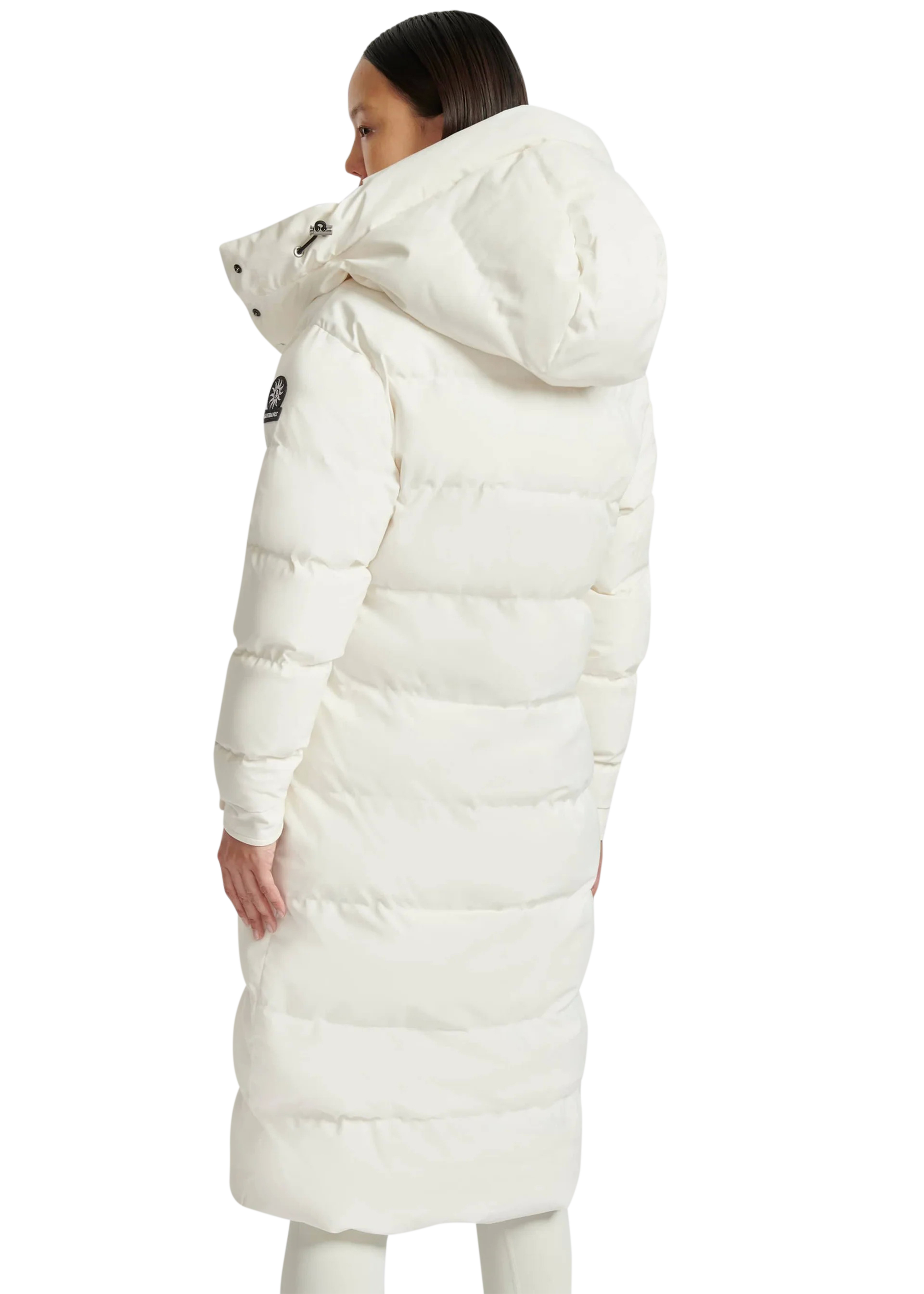 Person wearing a long white puffer coat on a white background