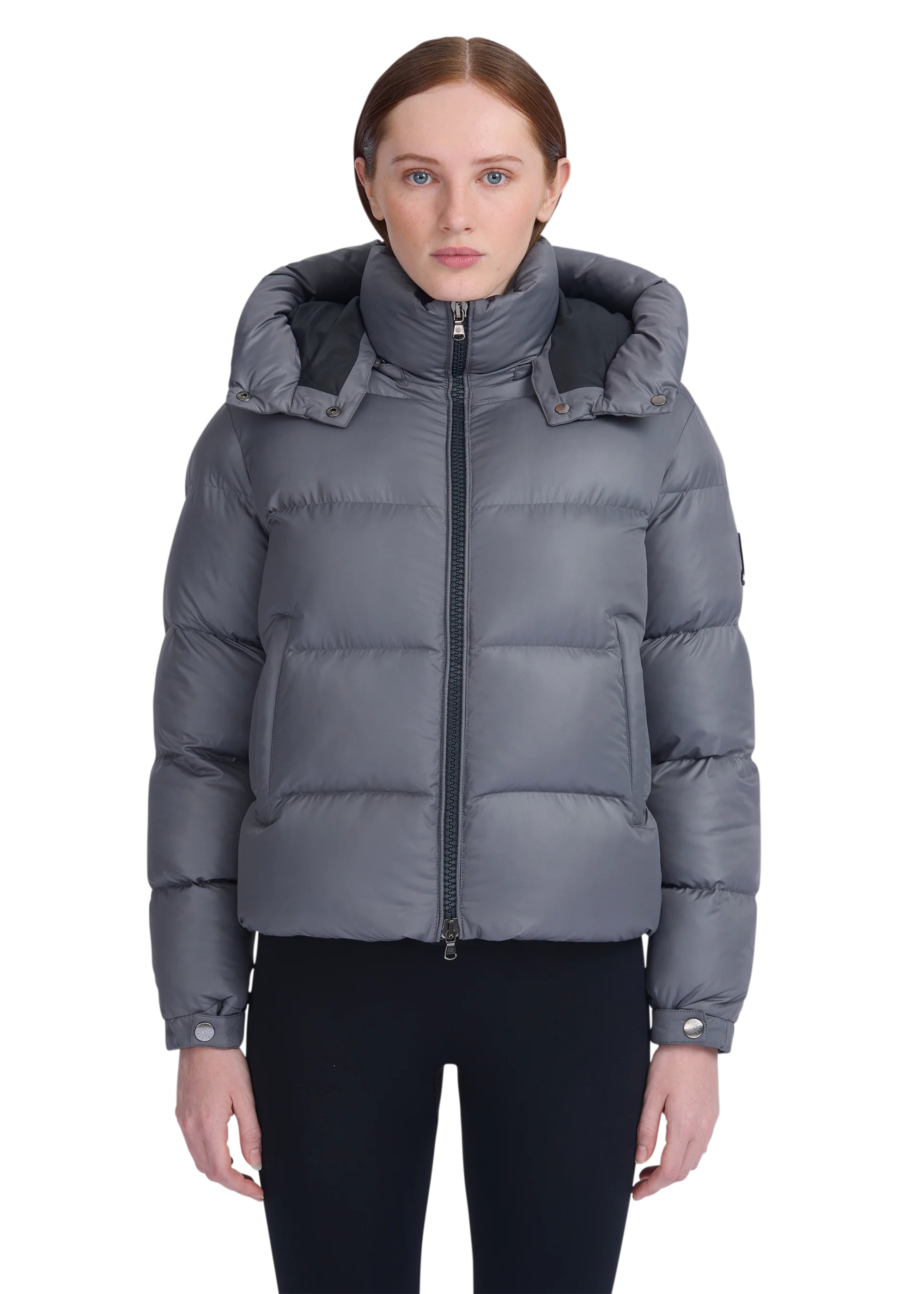 Gray puffer jacket worn by a model on a white background