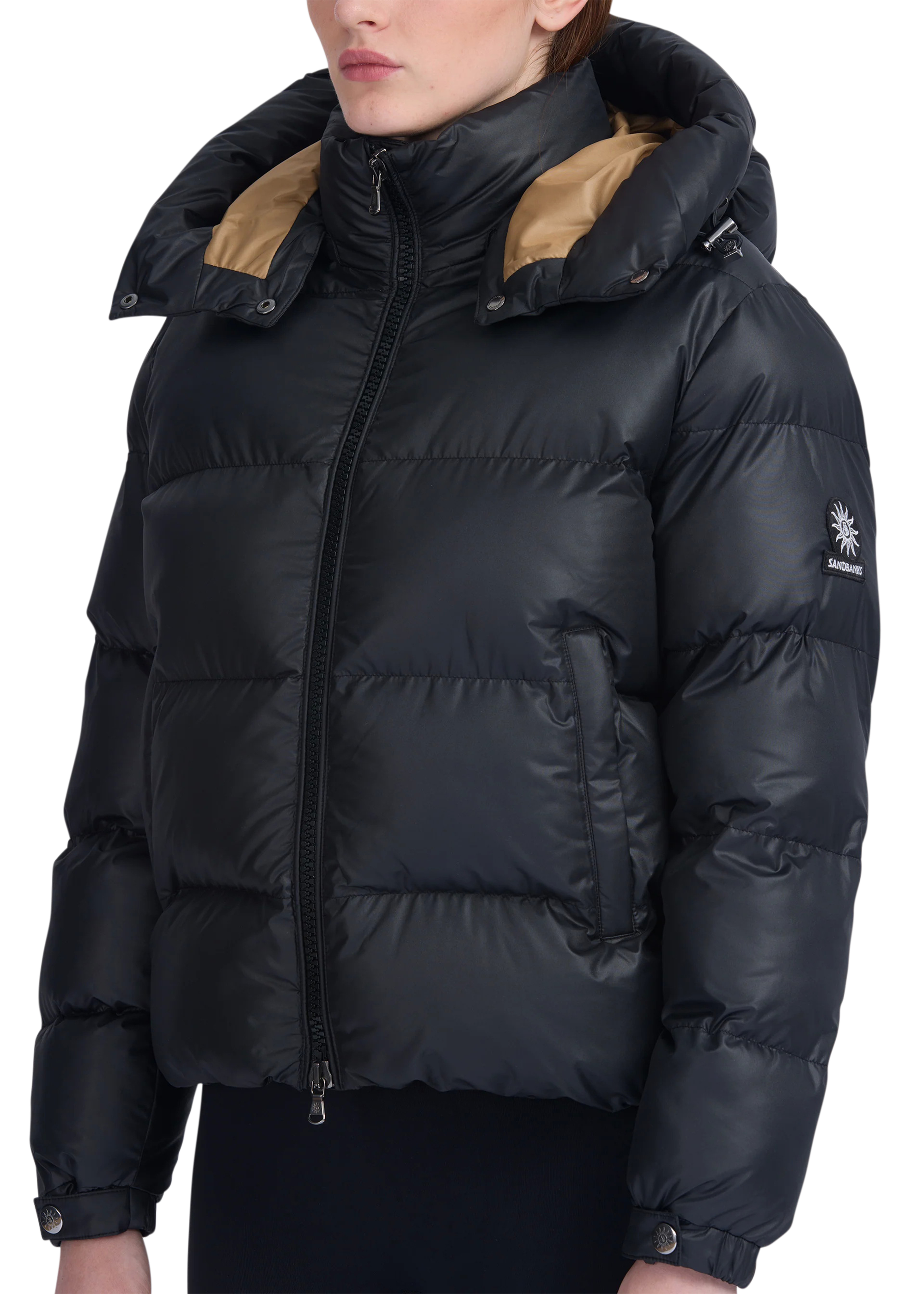 Black puffer jacket with beige lining on a white background