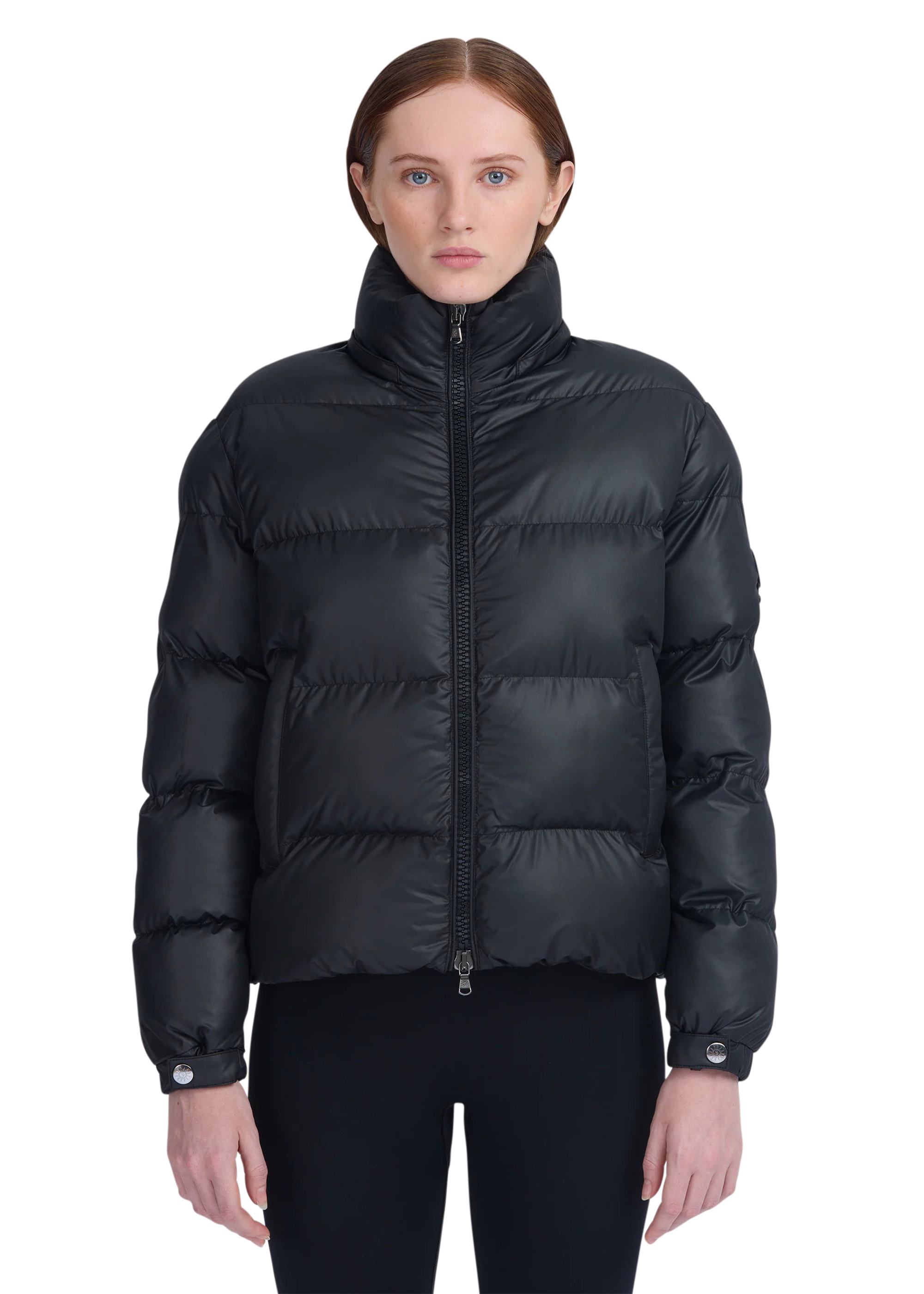 Black puffer jacket worn by a model on a white background