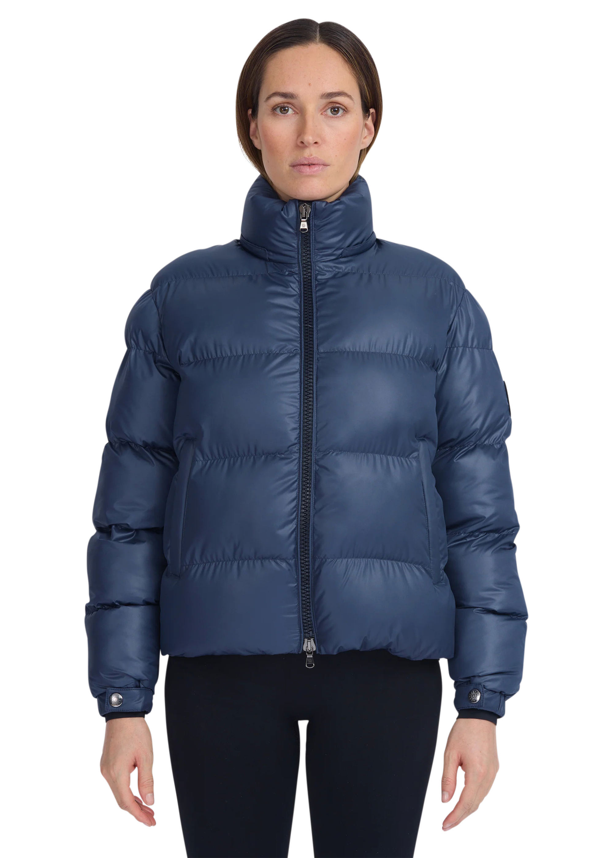 Woman wearing a blue puffer jacket on a white background