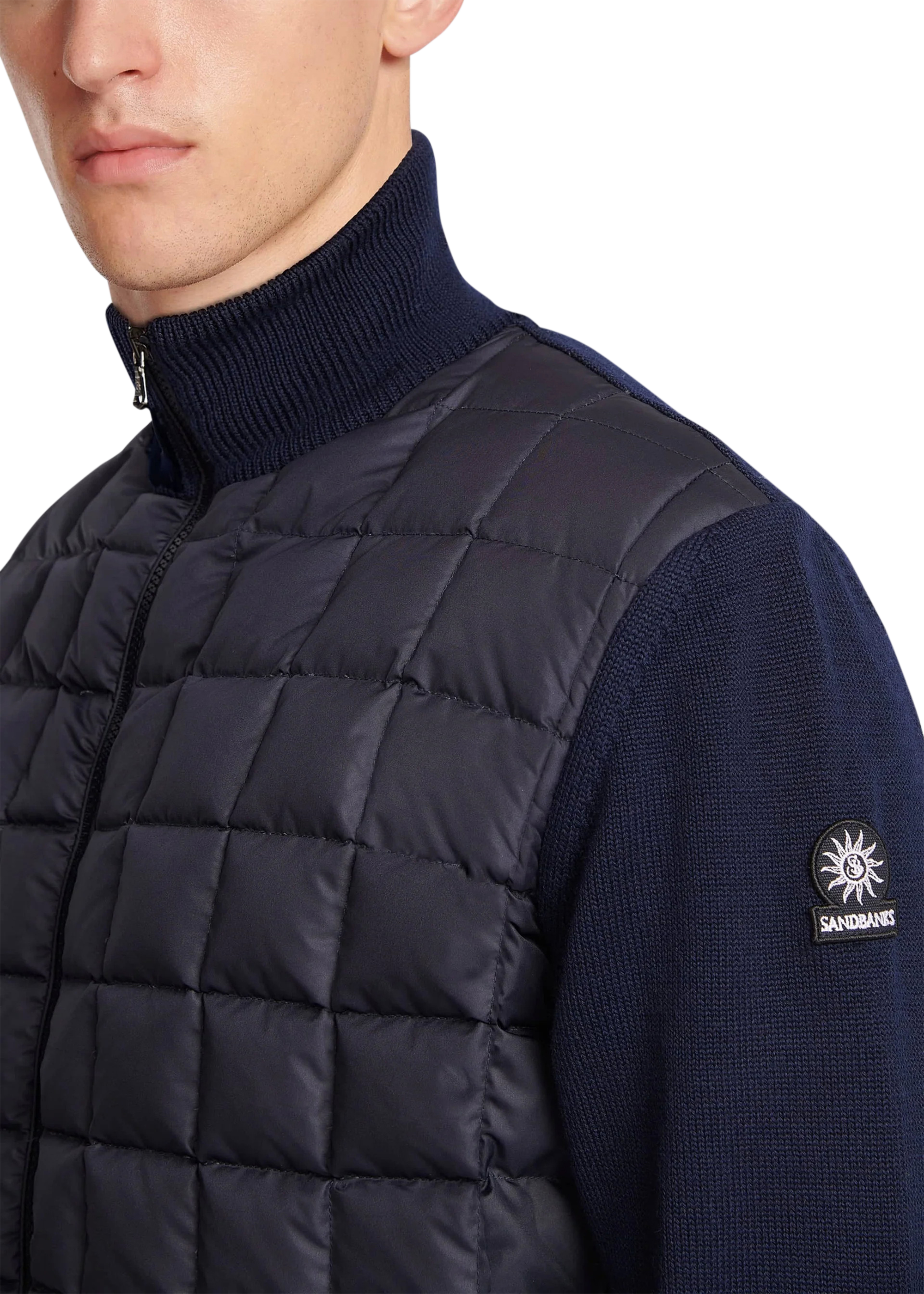 Navy puffer vest worn by a person with a brand logo on a white background