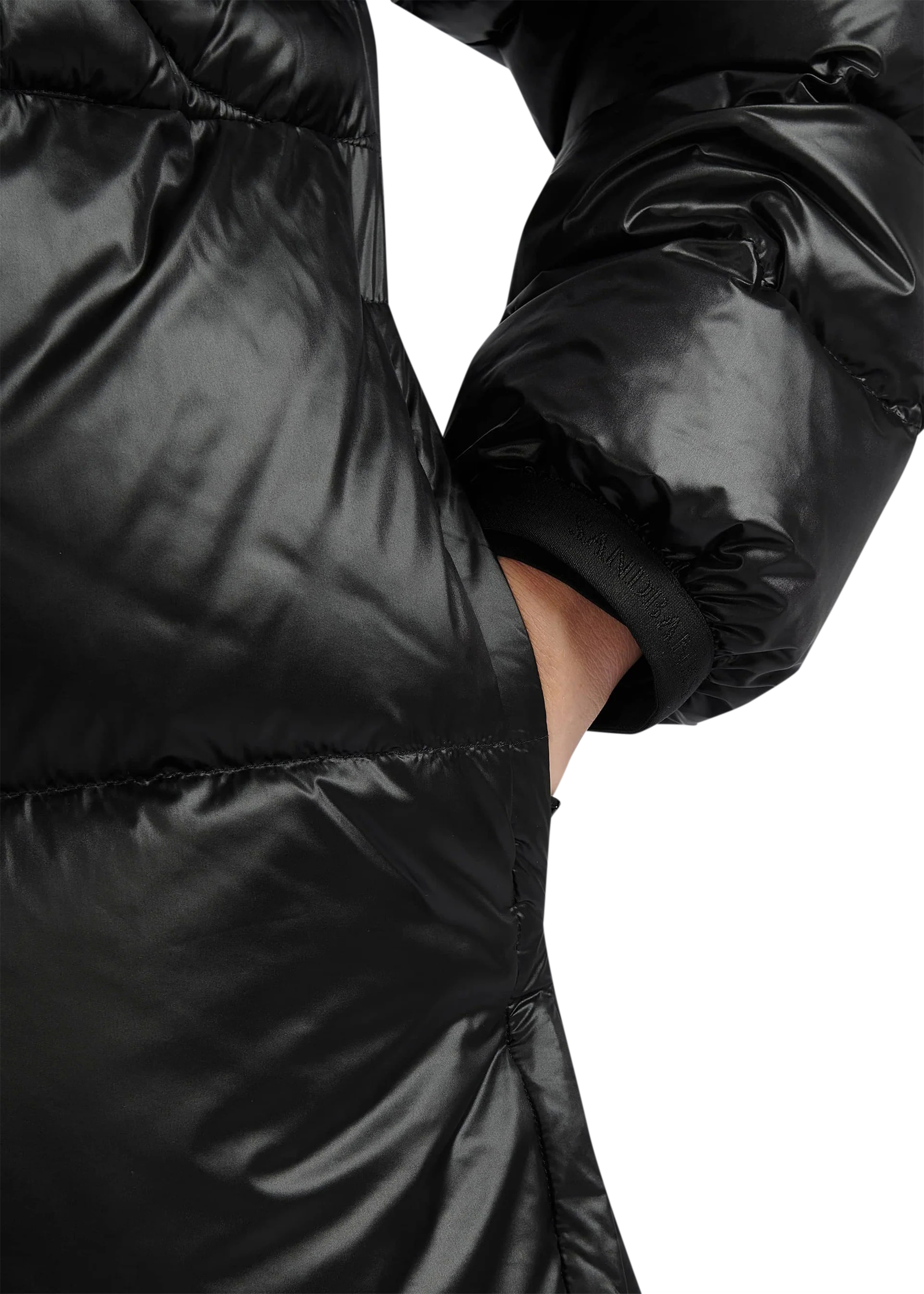 Close-up of a black puffer jacket on a white background