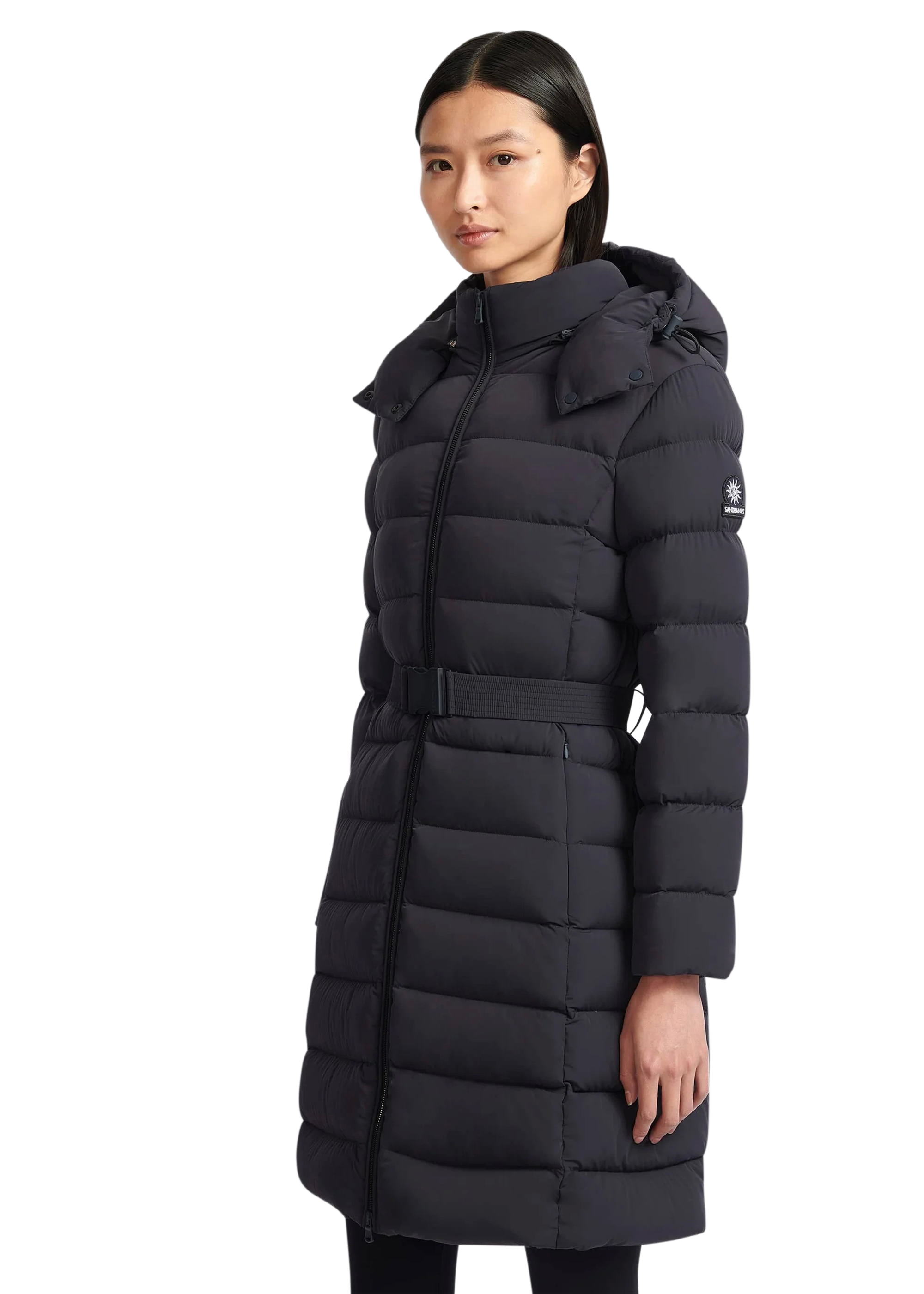 Woman wearing a black puffer coat on a white background