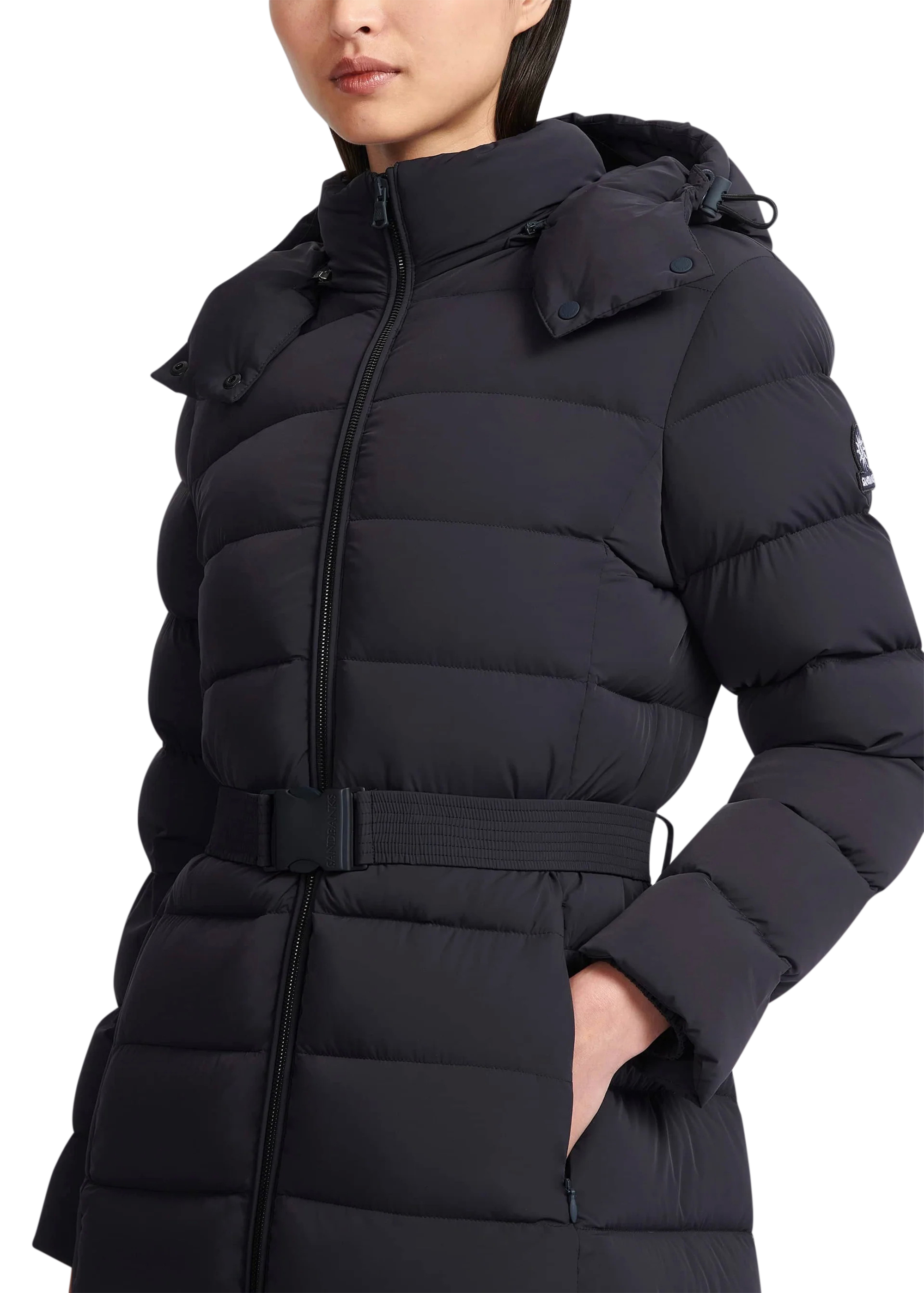 Black puffer coat worn by a person on a white background