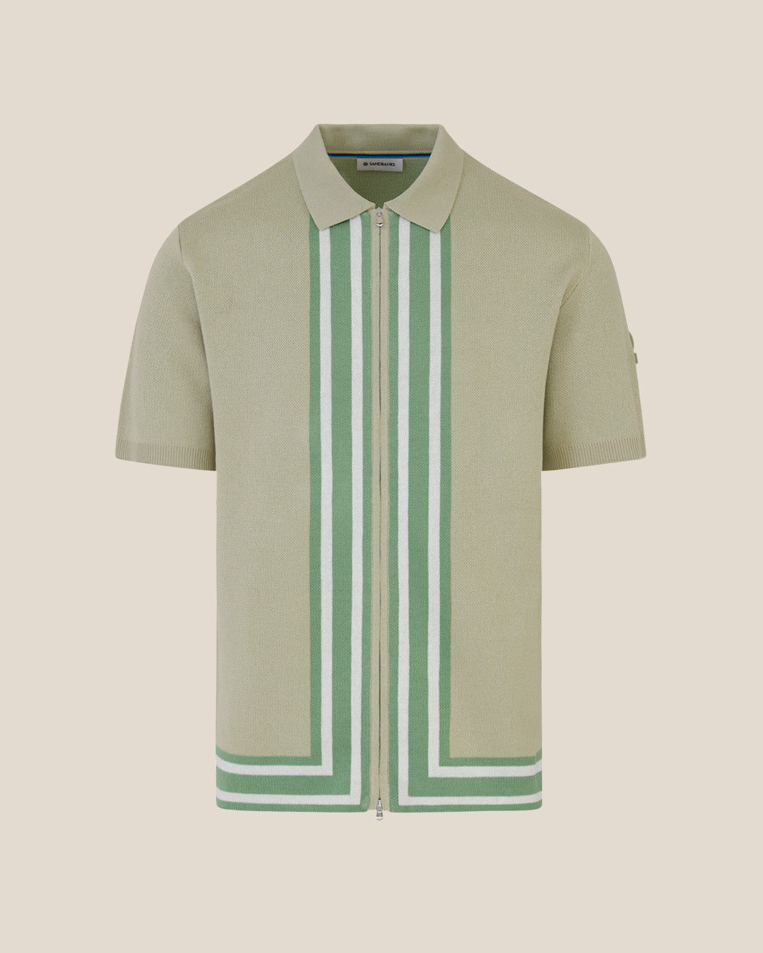 Green polo shirt with white and green striped collar on a beige background