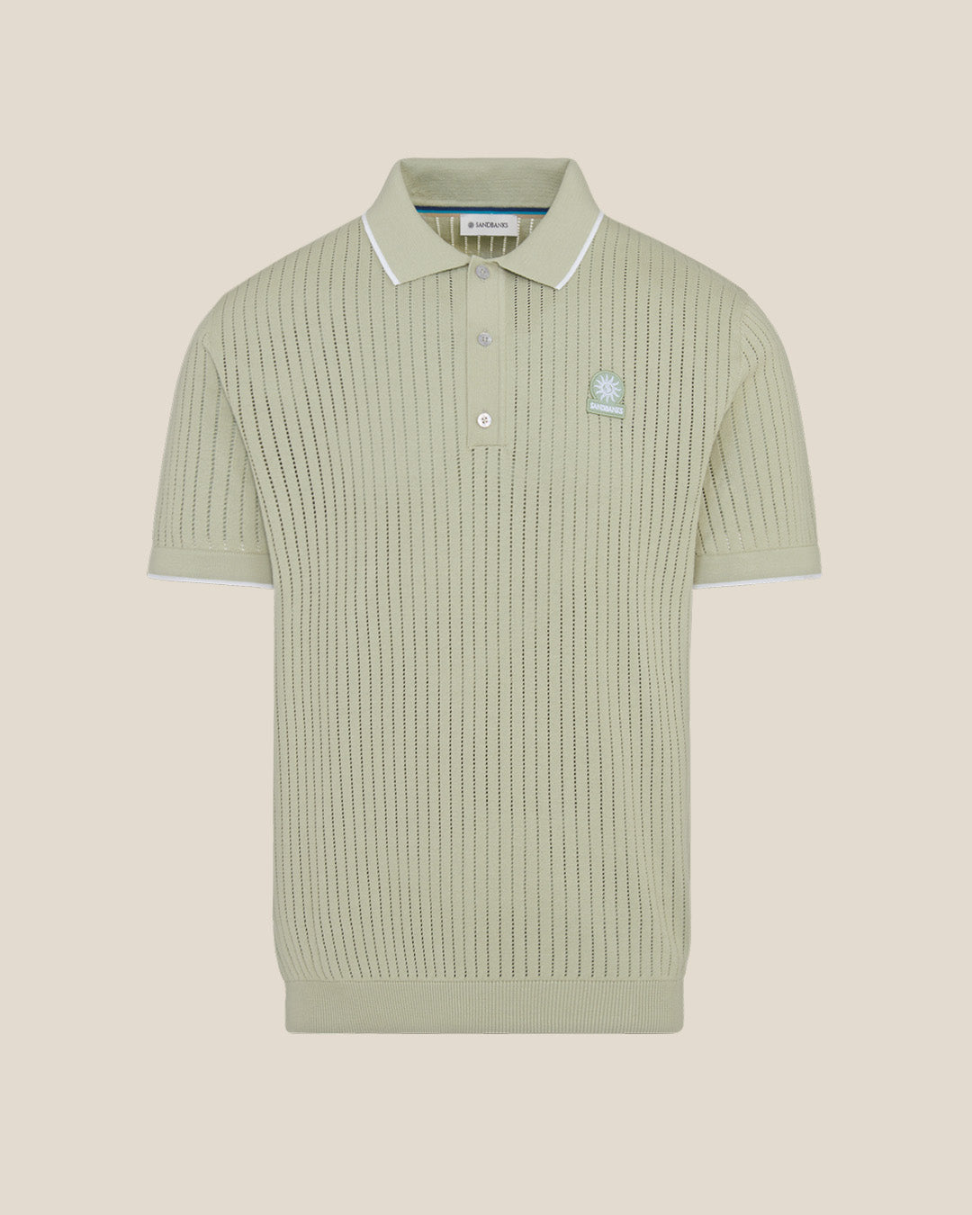 Green ribbed polo shirt with a brand logo on a beige background
