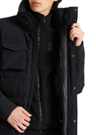 Person wearing a black jacket with a brand logo on a white background