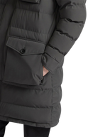 Close-up of a dark gray puffer jacket with front pocket on a white background