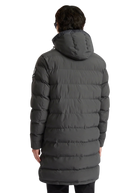 Person wearing a long gray puffer coat on a white background