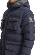 Navy blue winter jacket with a brand logo on the sleeve against a white background