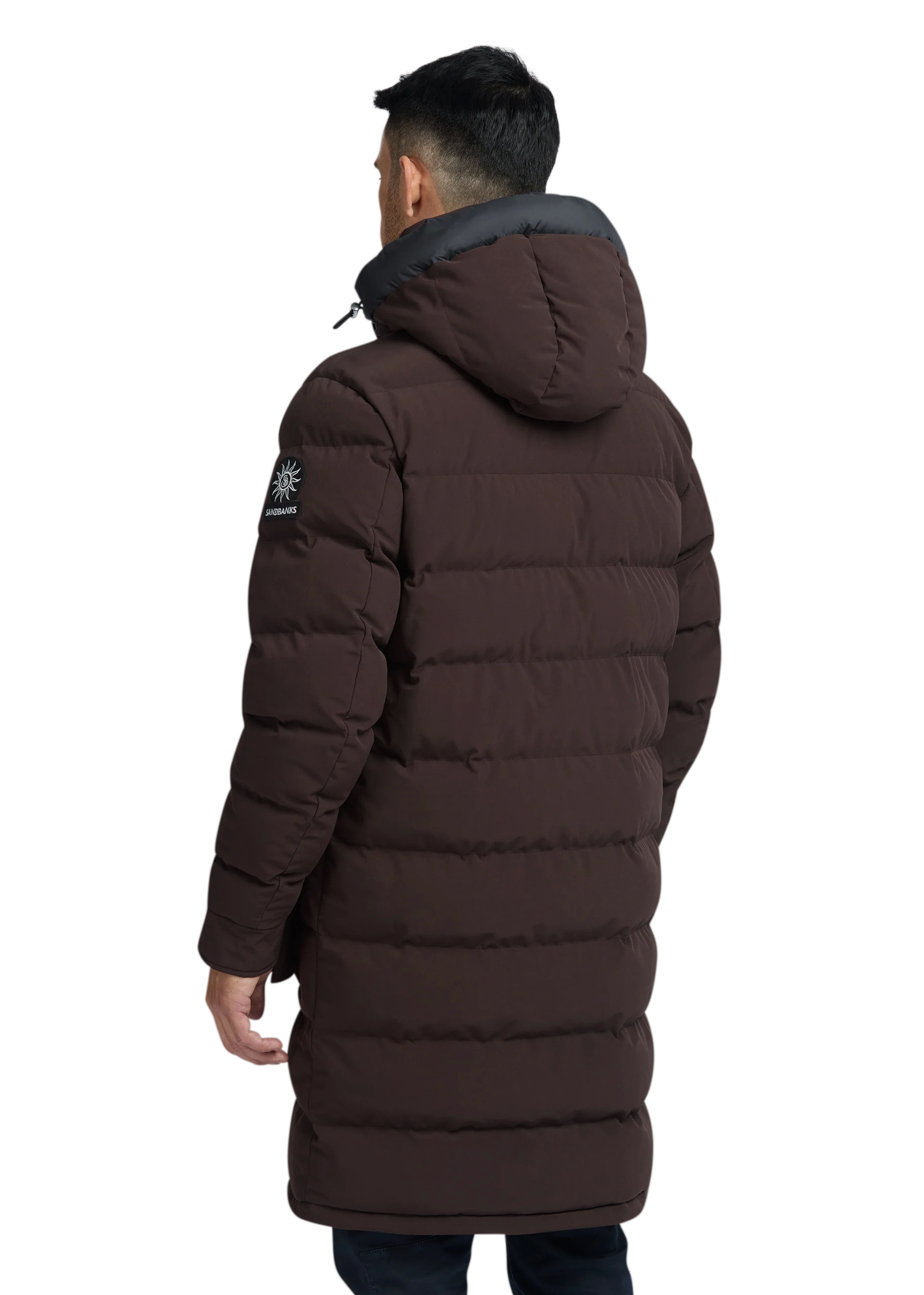 Man wearing a brown puffer jacket on a white background