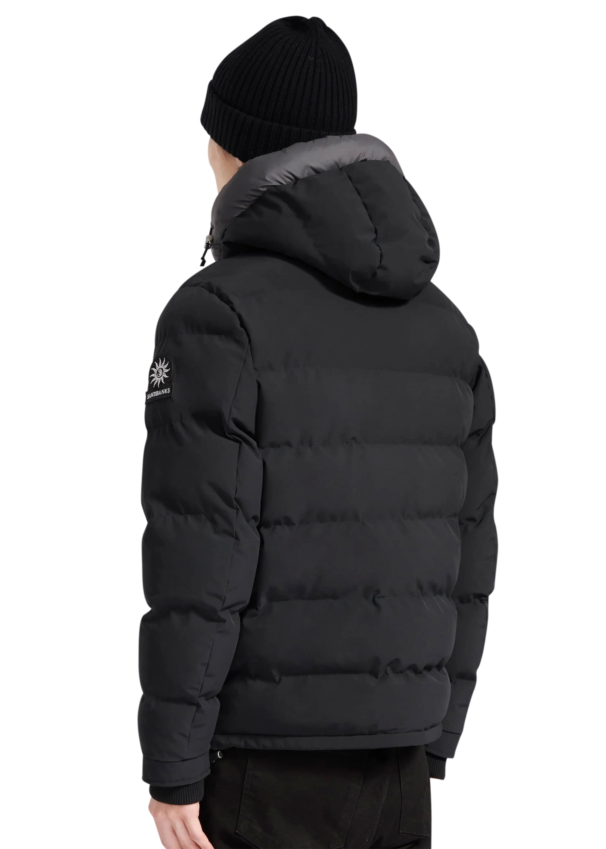 Person wearing a black puffer jacket with a brand logo on a white background