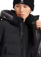 Person wearing a black puffer jacket with 'Sandbanks' branding.