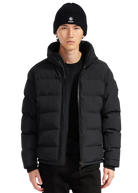 Person wearing a black puffer jacket and beanie on a white background