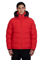 Man wearing a red puffer jacket with black accents on a white background