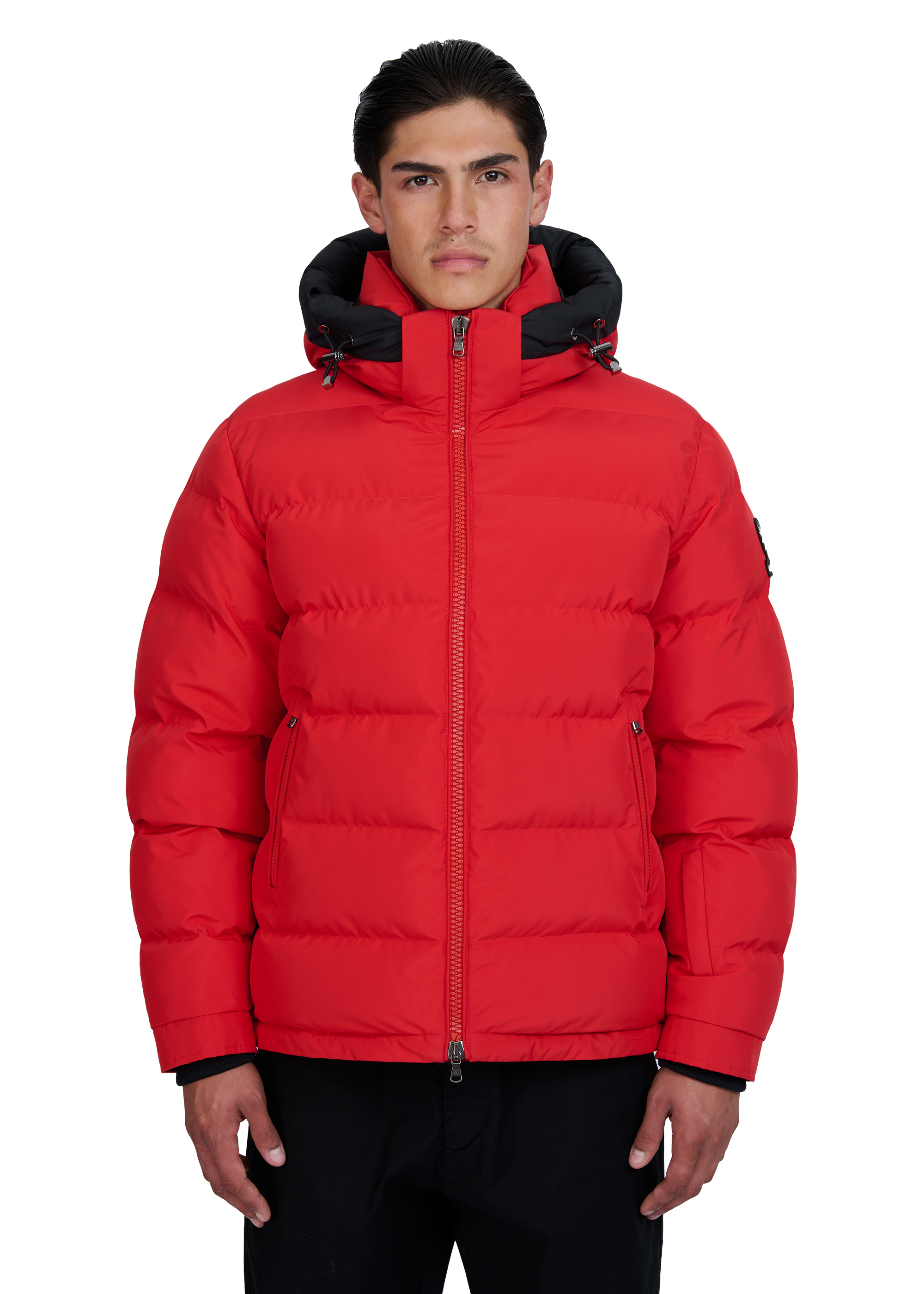 Man wearing a red puffer jacket with black accents on a white background