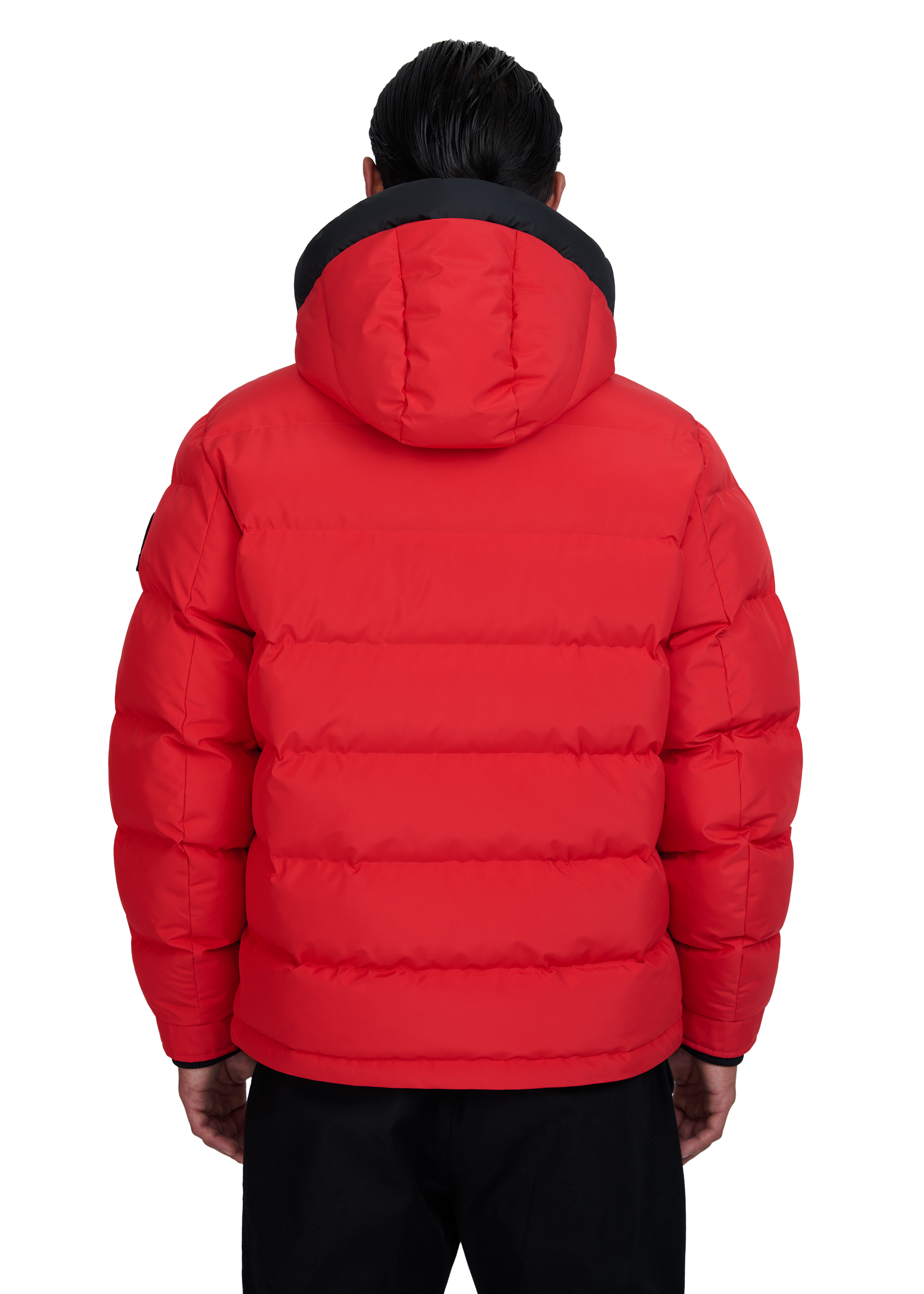 Red puffer jacket with black trim worn by a person on a white background