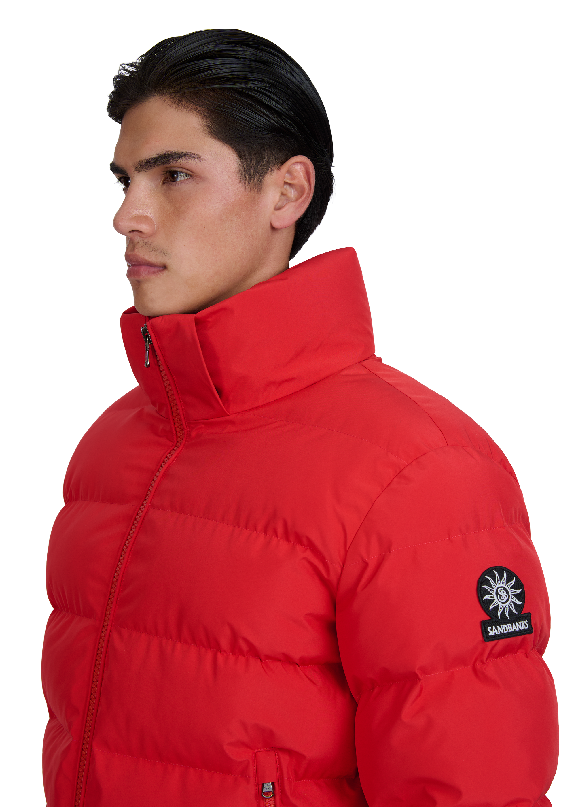 Man wearing a red puffer jacket with a brand logo on a white background