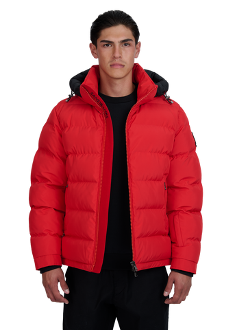 Man wearing a red puffer jacket on a white background
