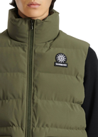 Green puffer vest with a logo on a white background