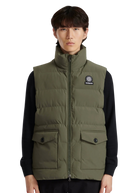 Person wearing a green puffer vest with a brand logo on a white background