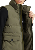 Person wearing a green puffer vest with a white background